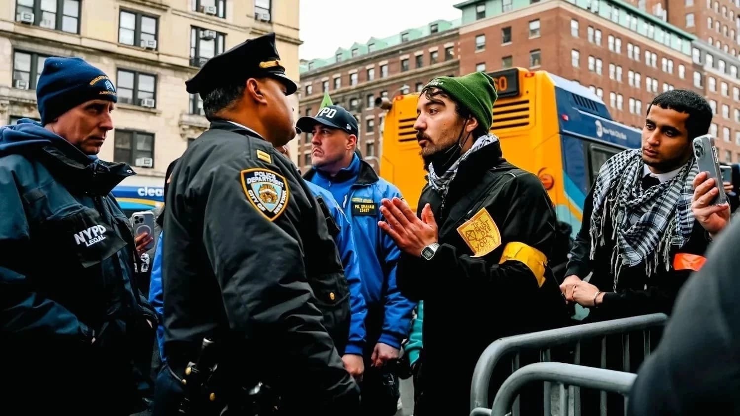 Facing the NYPDs, the green hat man is making a request.