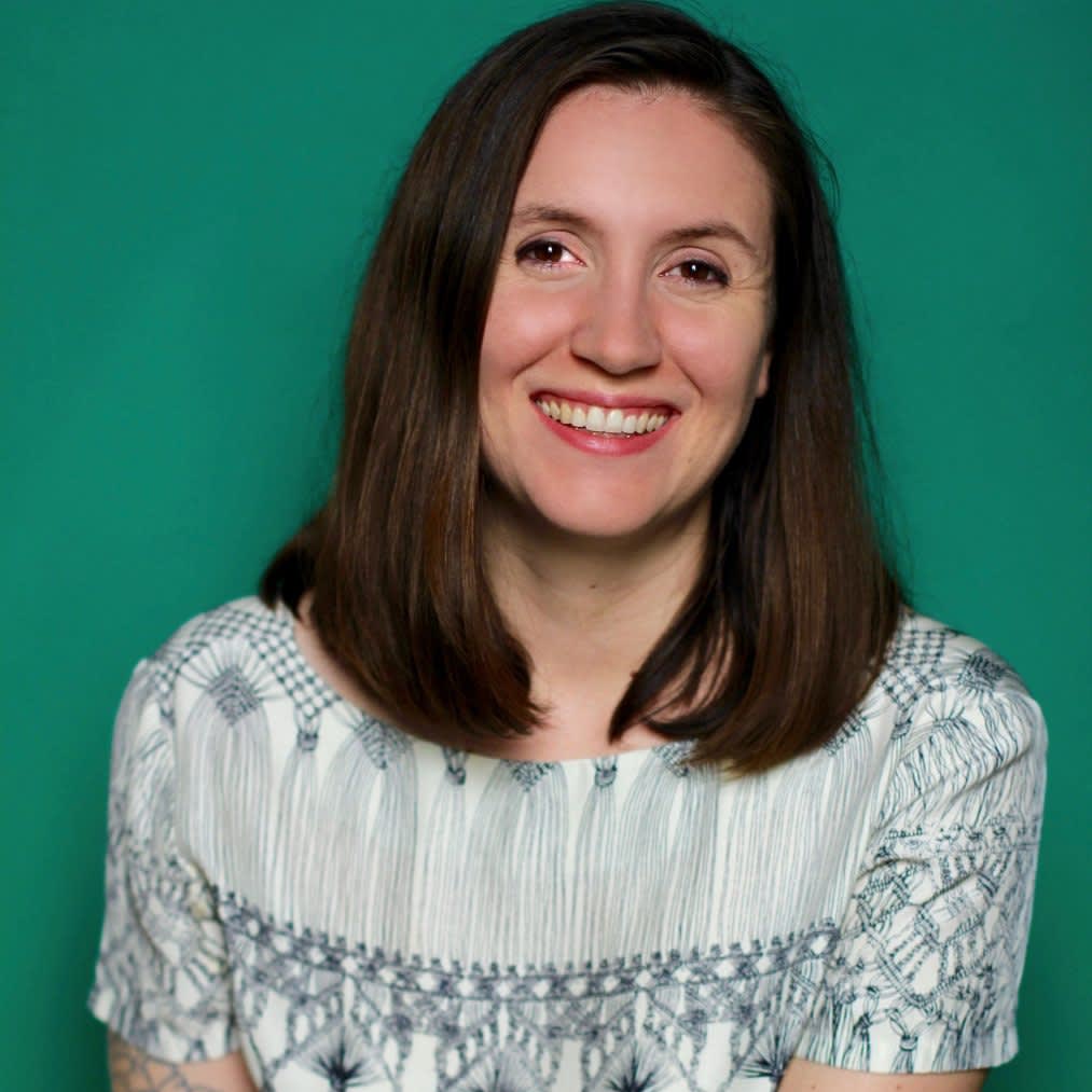 Portrait of Christina Roussos against a green background