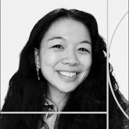 black and white image of woman smiling with long hair