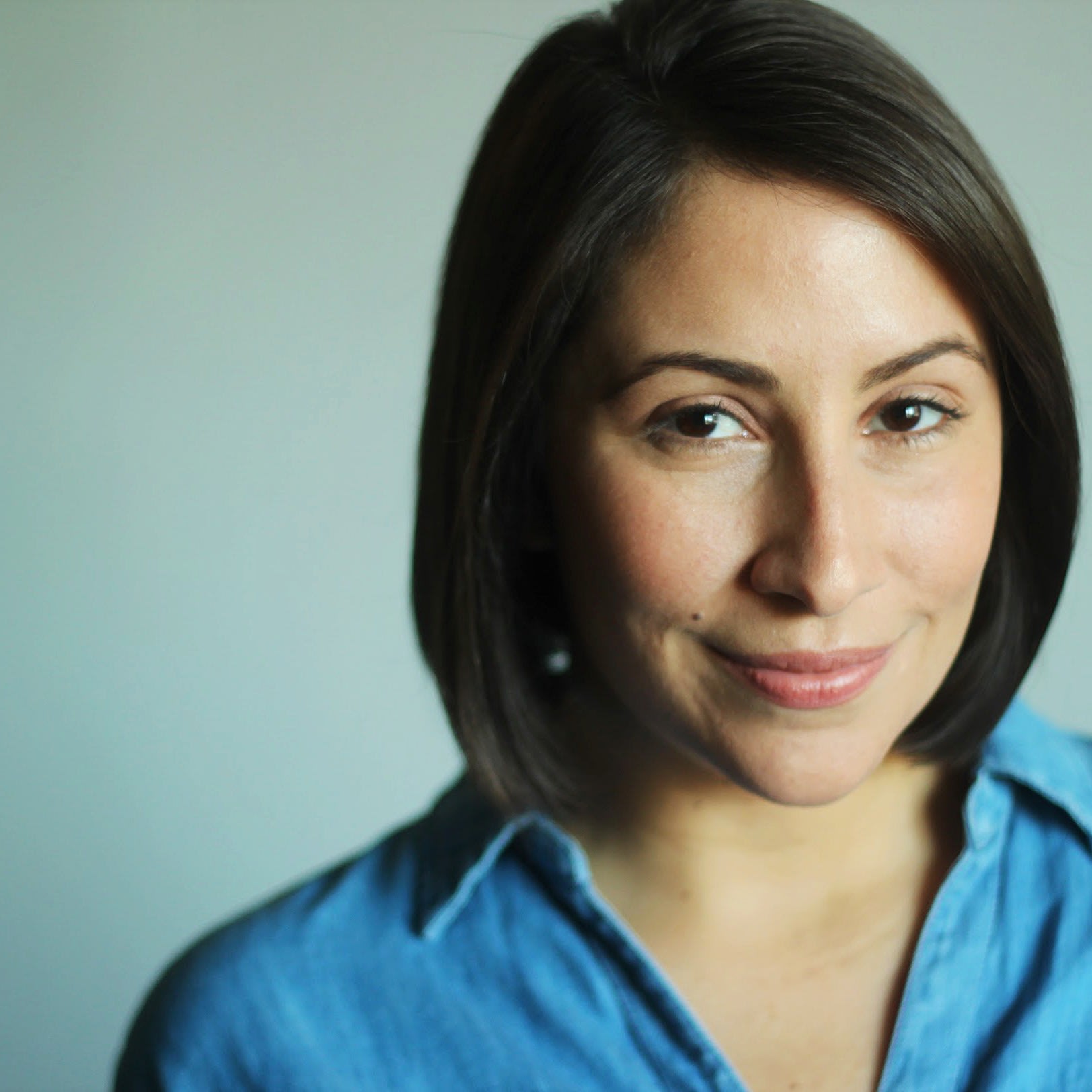 headshot of woman in blue shirt