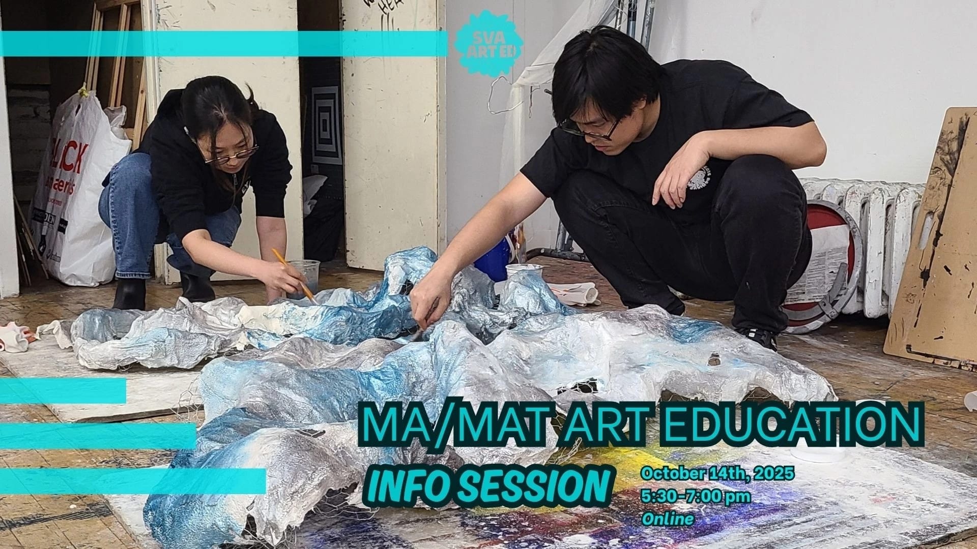 Two people kneel over papier-mâché forms painted with blue, silver and white paint.