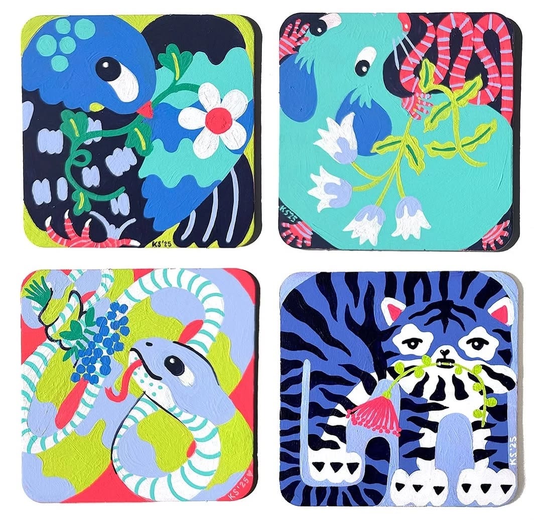 Four coasters featuring various animals surrounded by colorful flowers.
