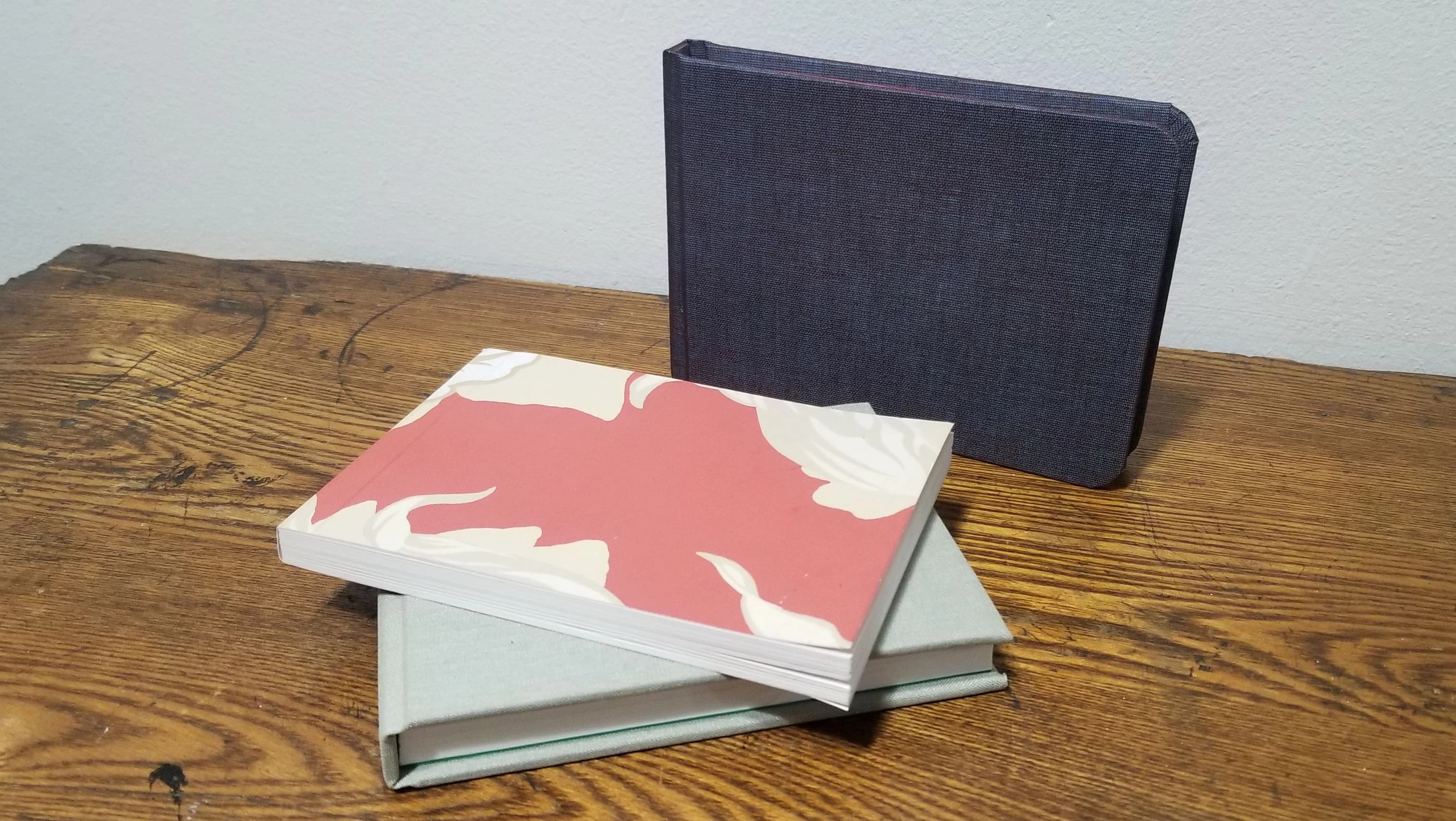 Three book on display, All perfect bound with different finishes. 
