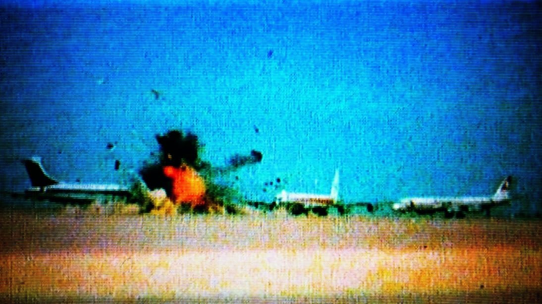 An airplane exploding while parked on the ground.