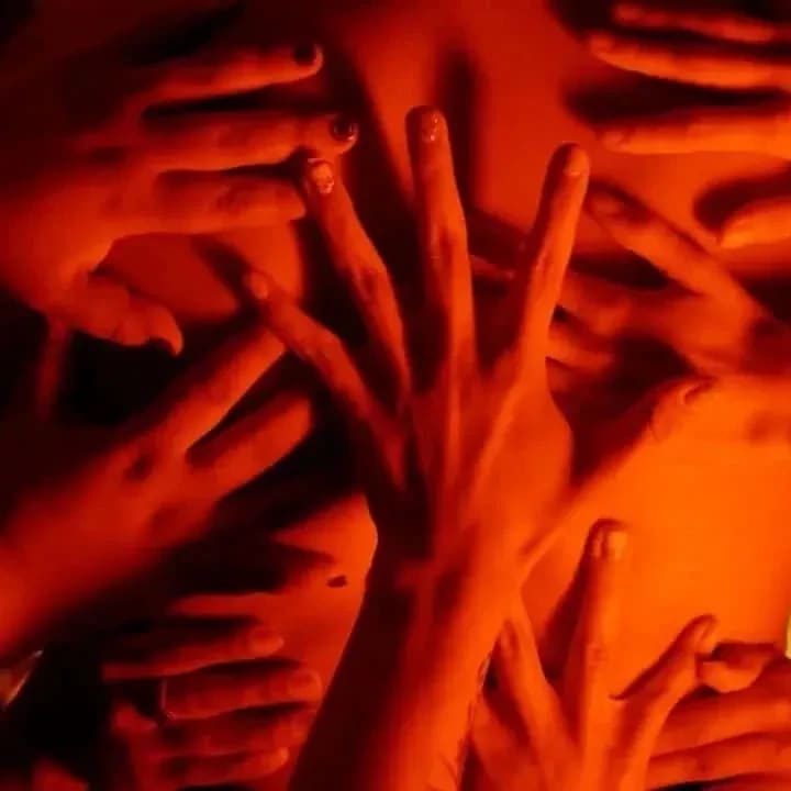 A diverse group of hands reaching upward towards a clear blue sky, symbolizing hope and unity.