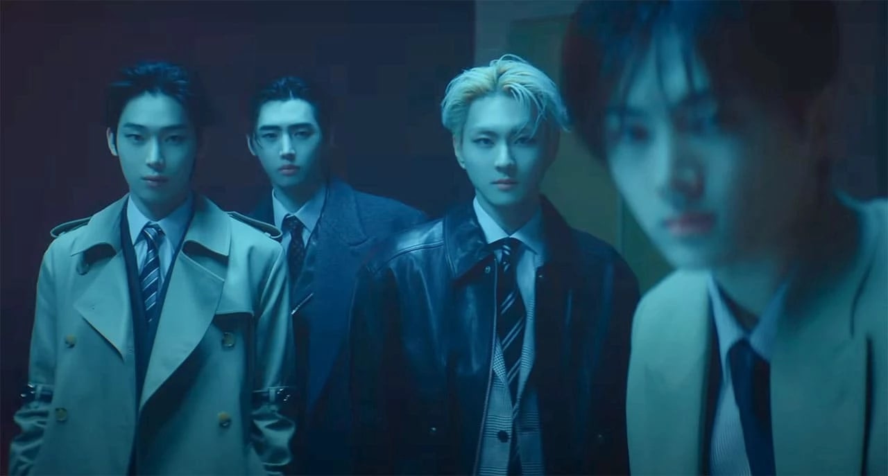 Four male kpop idols look at the viewer with a blue tone over the image.