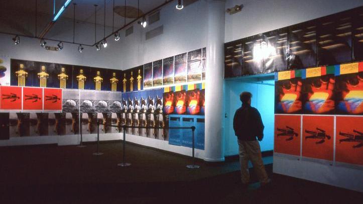 A man in a museum looking at postmodern art.