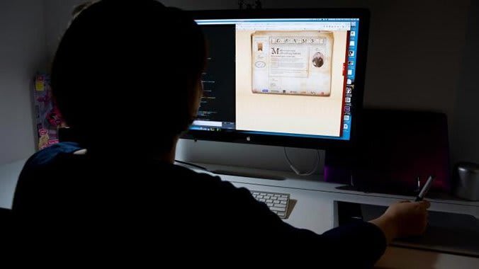 A photo of a person working on a computer.