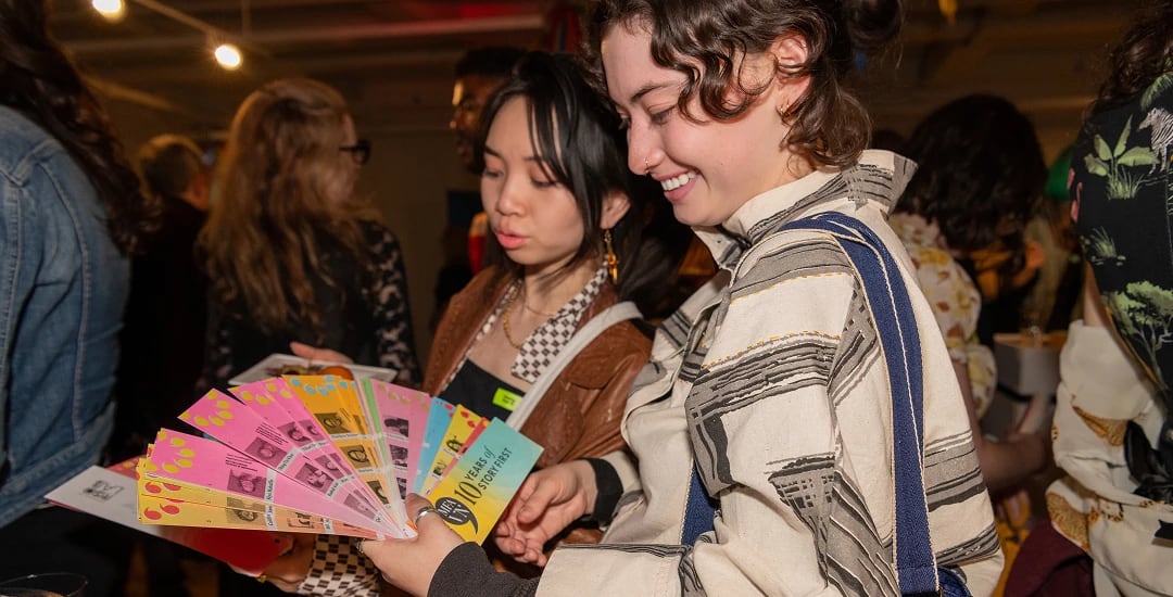 Two students looking at a sprawled out swatch book,