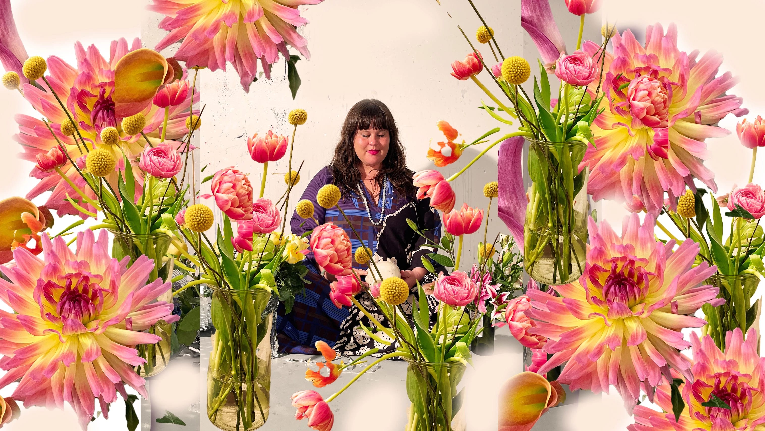 A woman with long hair sits meditating among the flowers.
