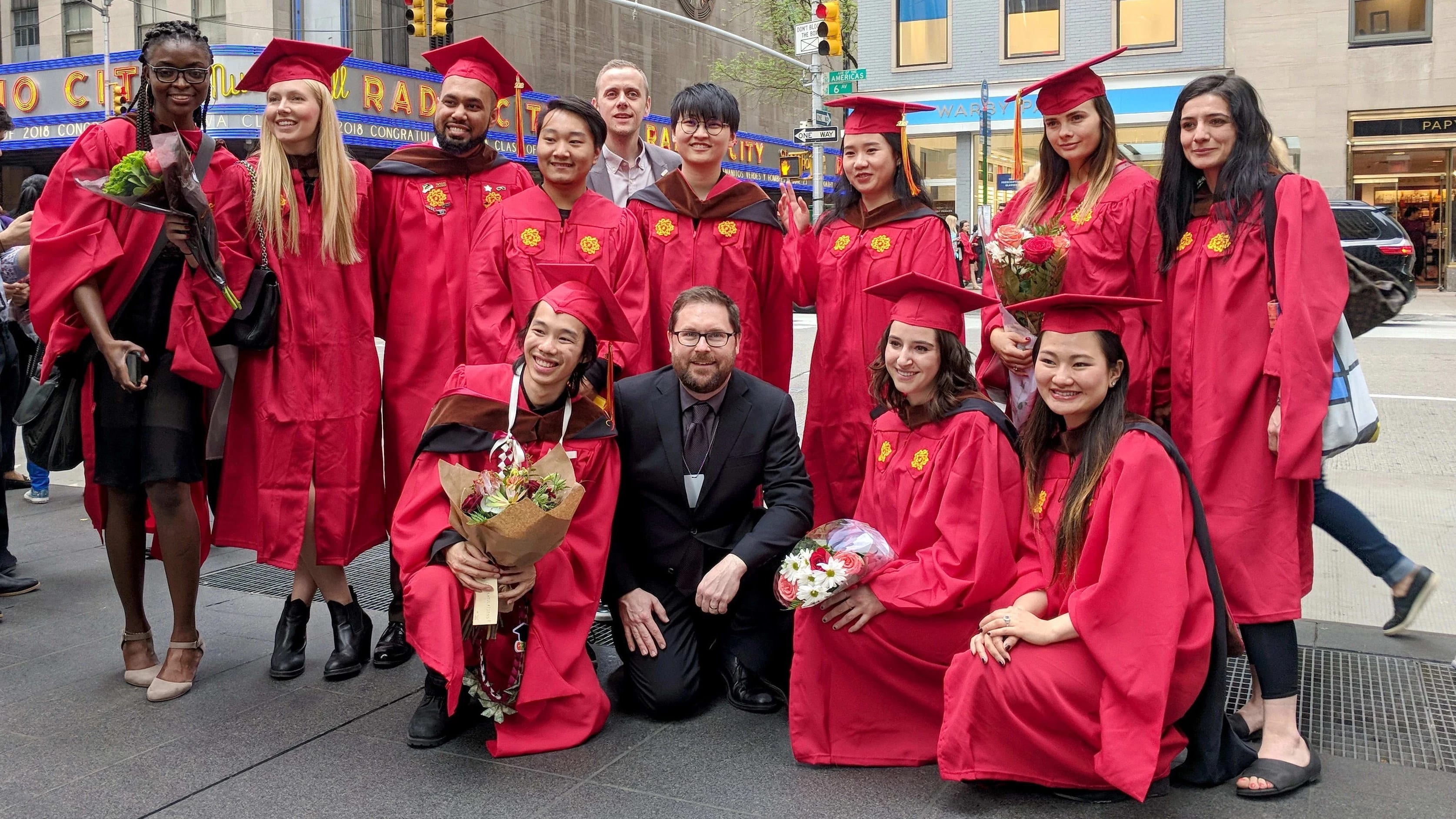 The graduating MPSDP class of 2019 stands on the street with the Radio City Music Hall in the background.