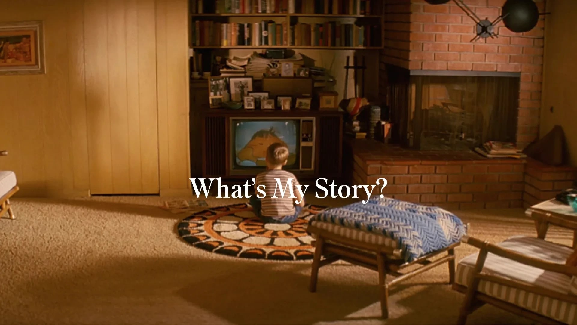 A small boy sits in the living room, staring at a TV; the text, "What's My Story?" appears in white in the center of the image.