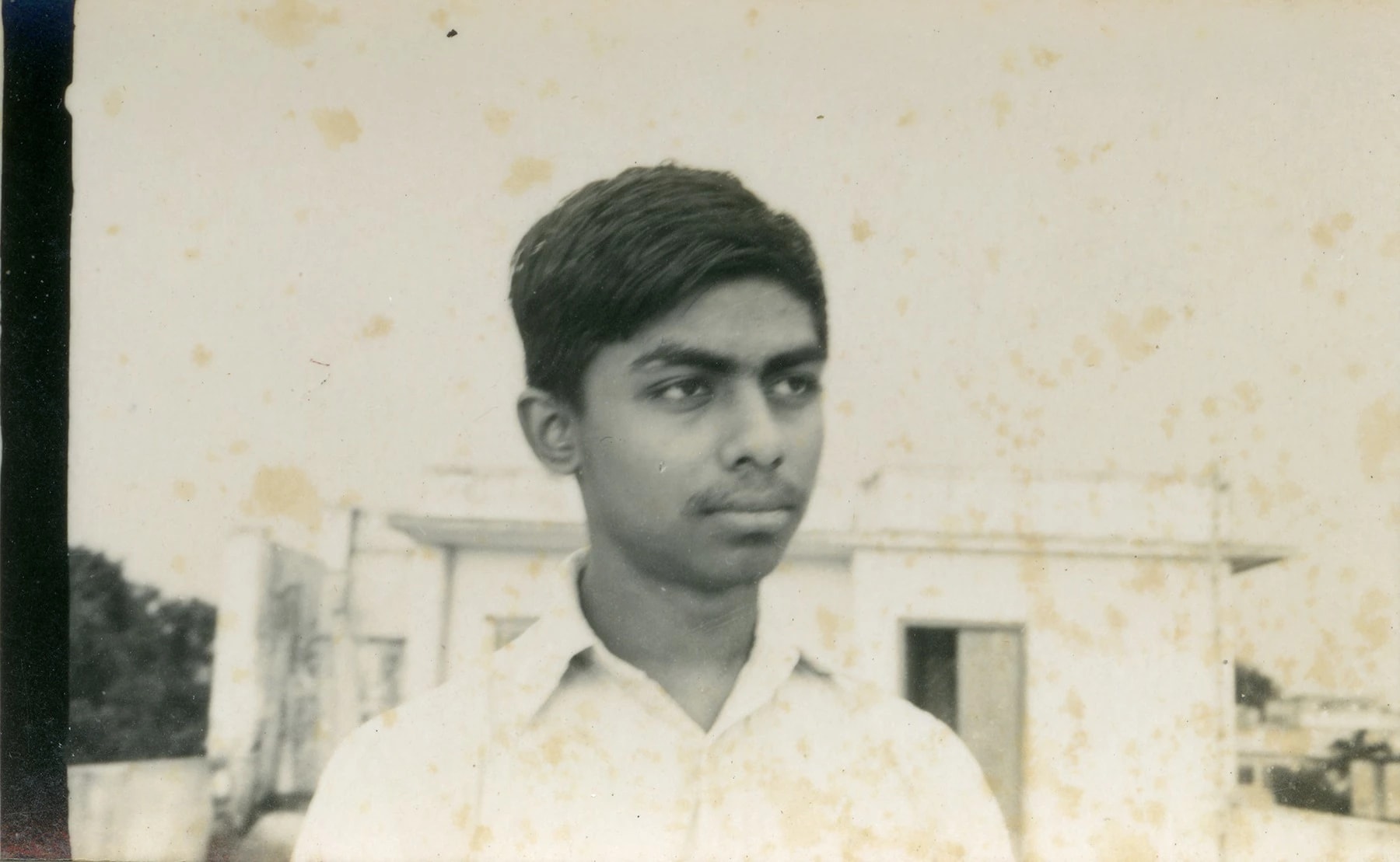 a black and white photo of a man in a white shirt