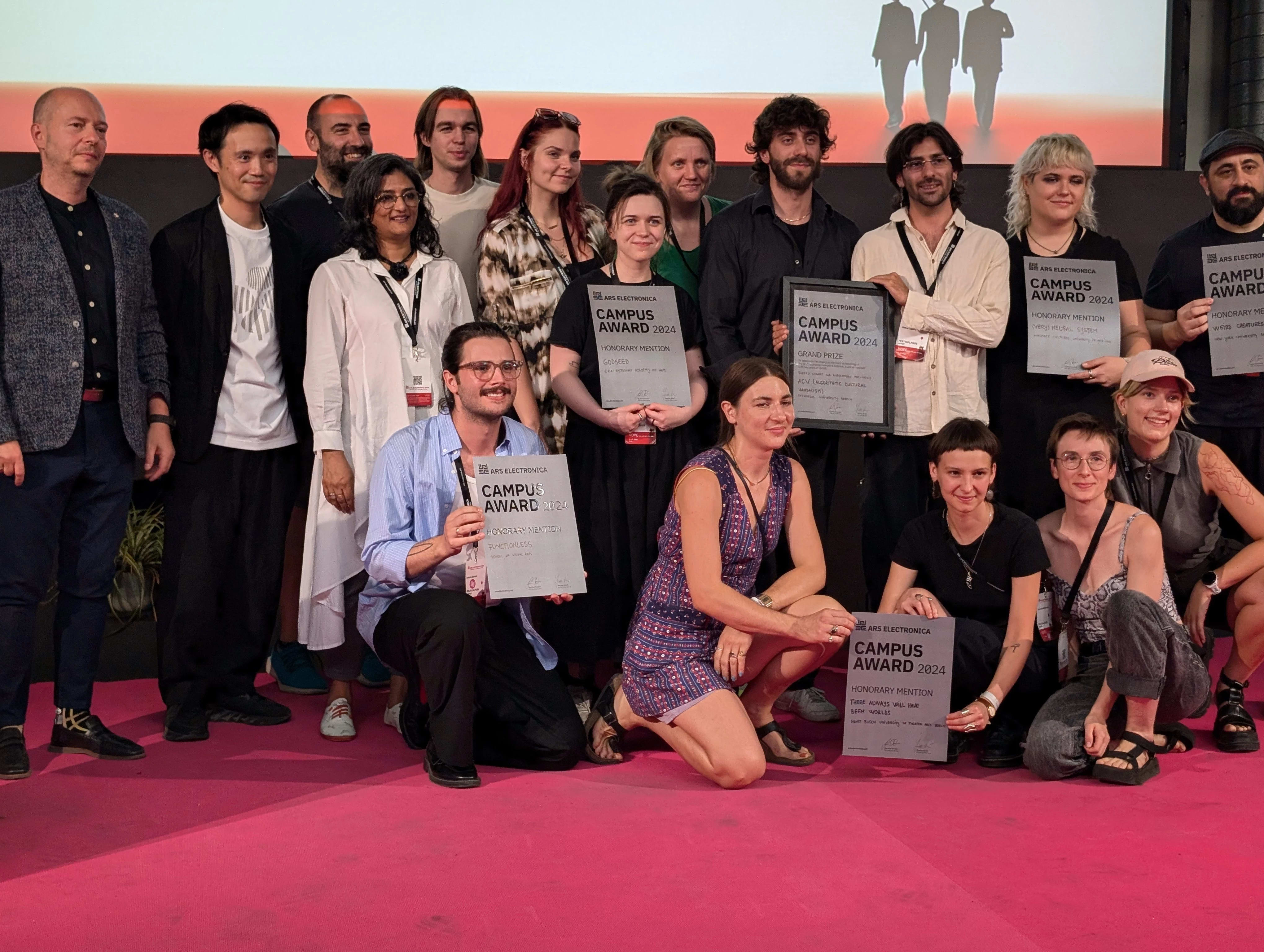 A group of award recipients pose for a photo
