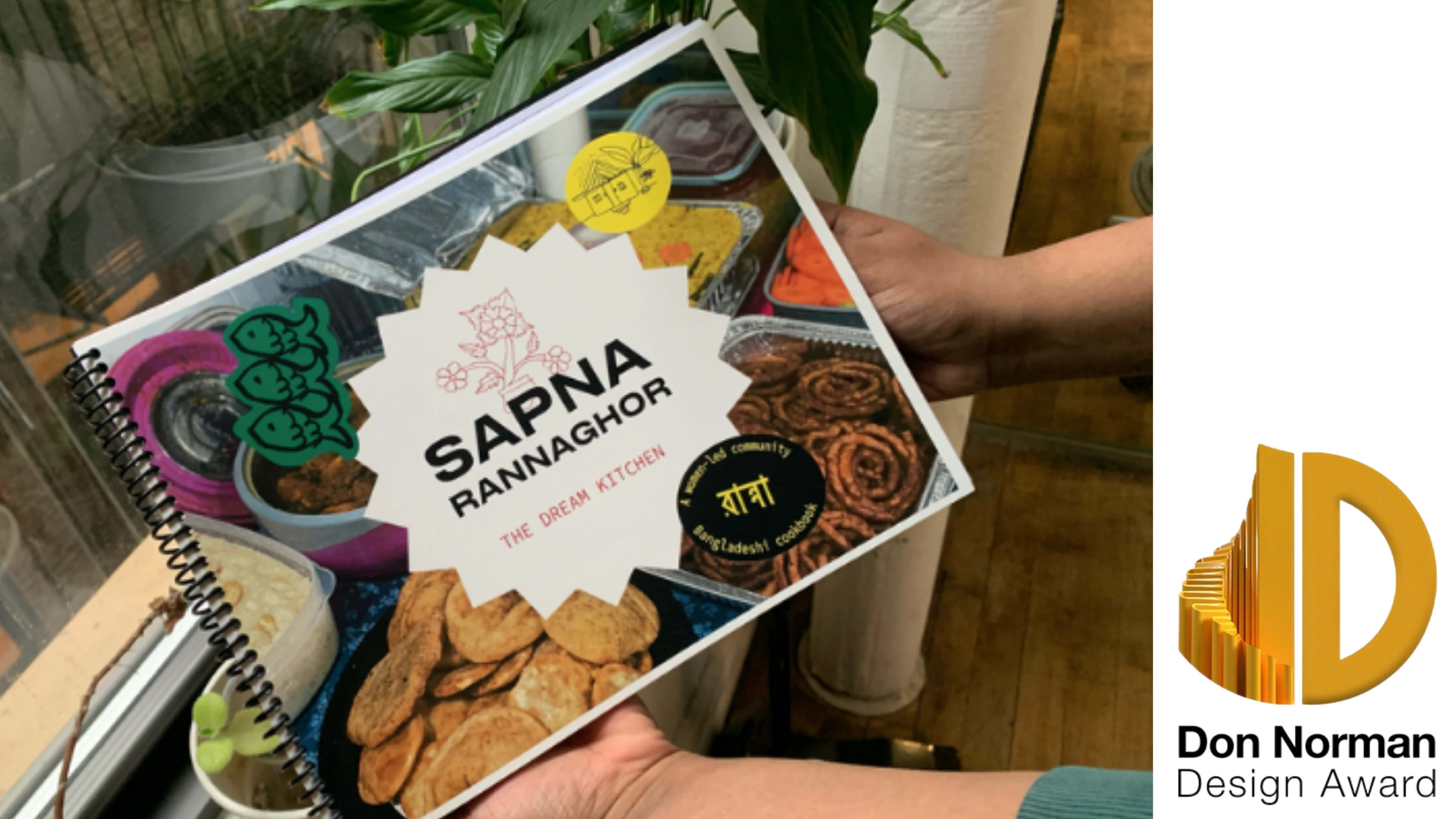 Hands holding book with Don Norman Design Award logo in right corner