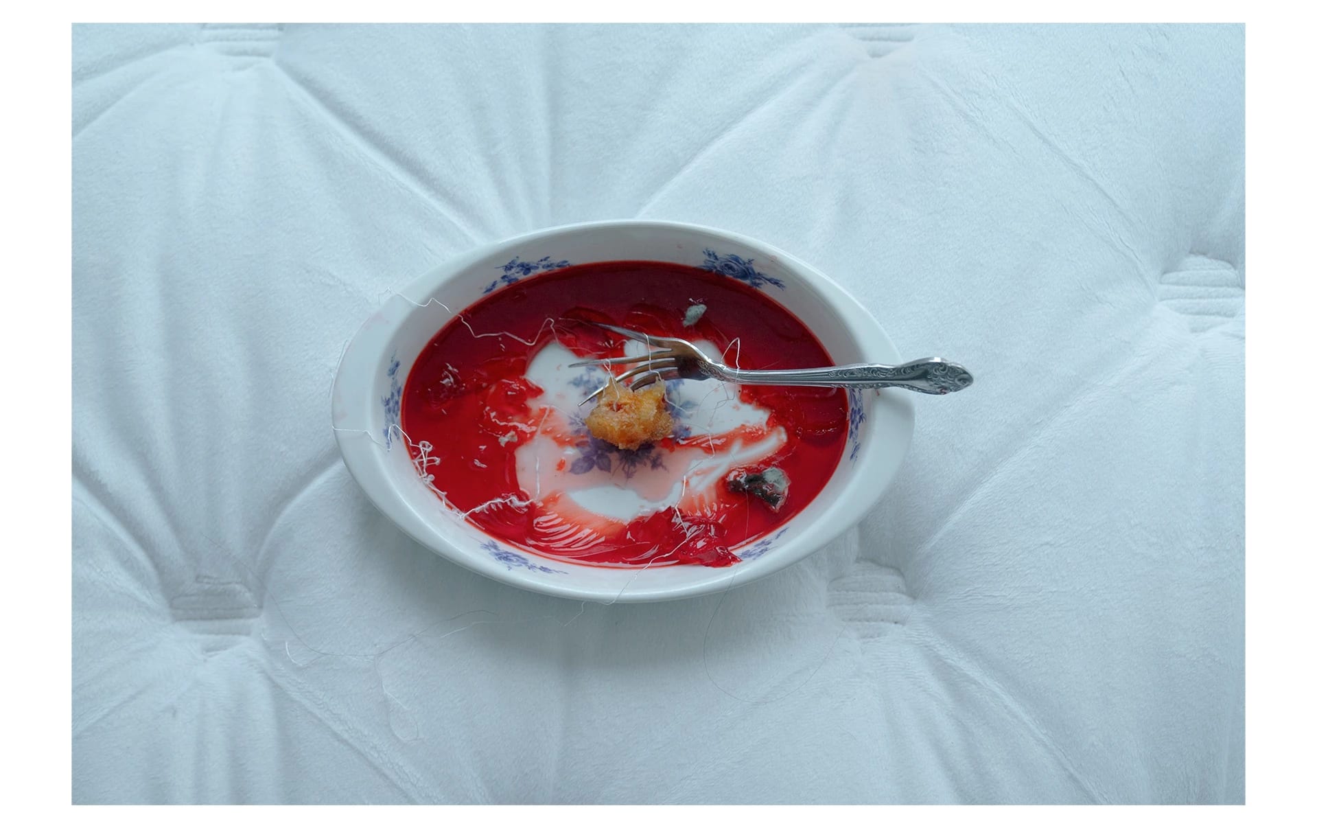  Image of a bowl of rotten jello, peach pit on a bent fork, and lines connected.