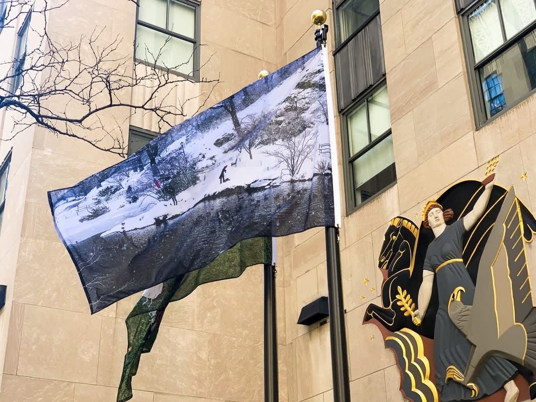 Photo of a flag of a photograph by Natcha Wongchanglaw at Rockefeller Center.