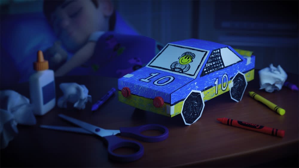 A 3D rendered image of a paper car on a table in front of a boy sleeping in a hospital bed.