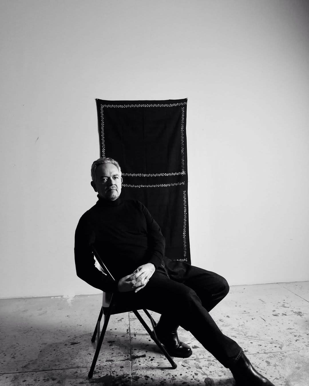 Photograph of man sitting in chair.