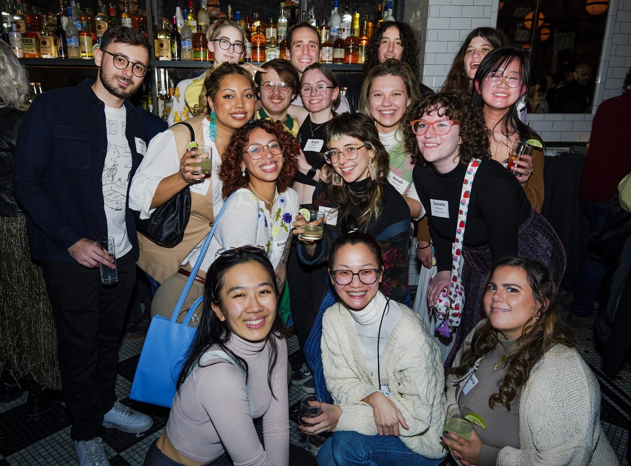 A group of people pose in a restaurant for a group photo 