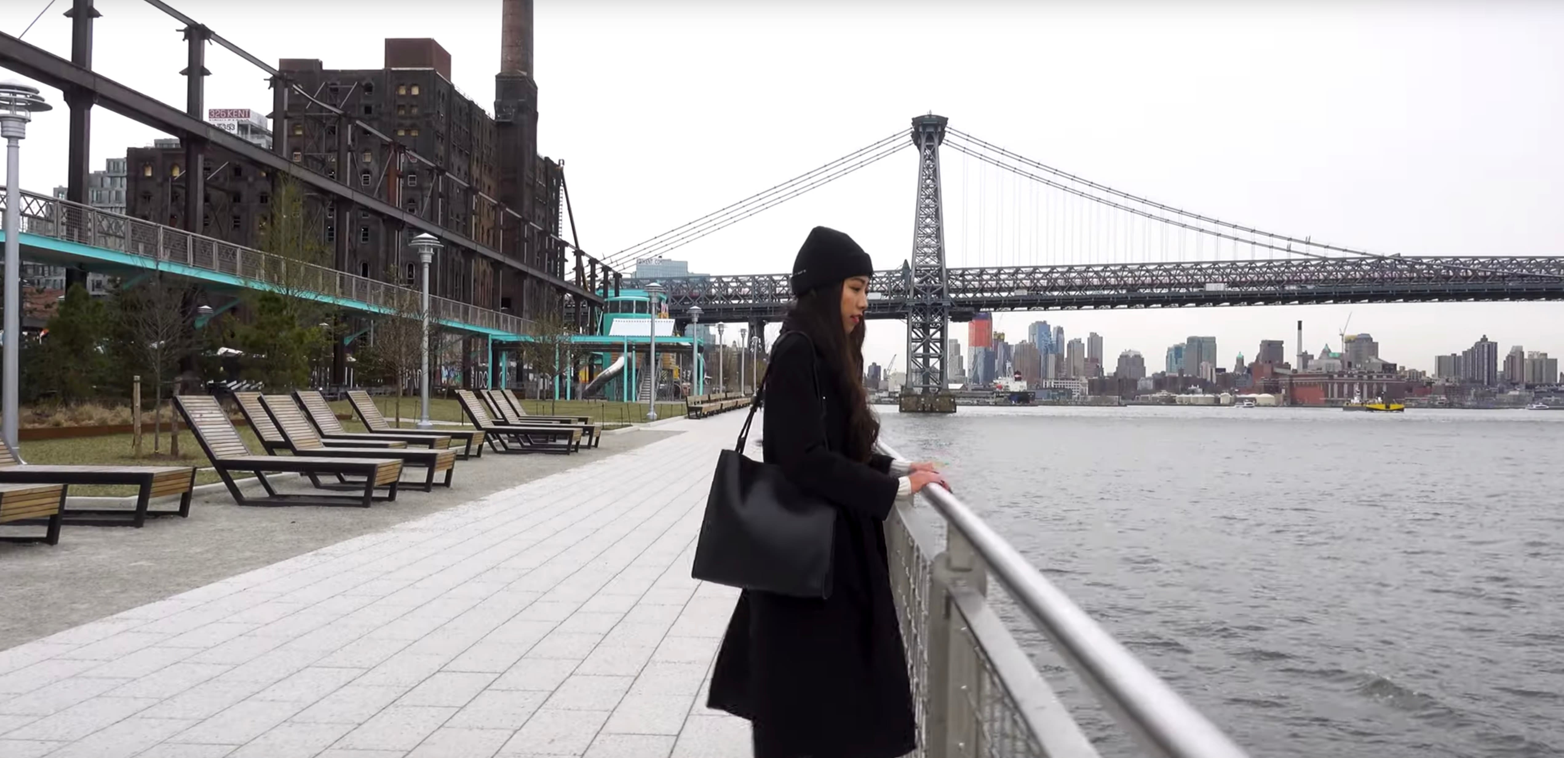 Still of a person standing next to the river in NYC