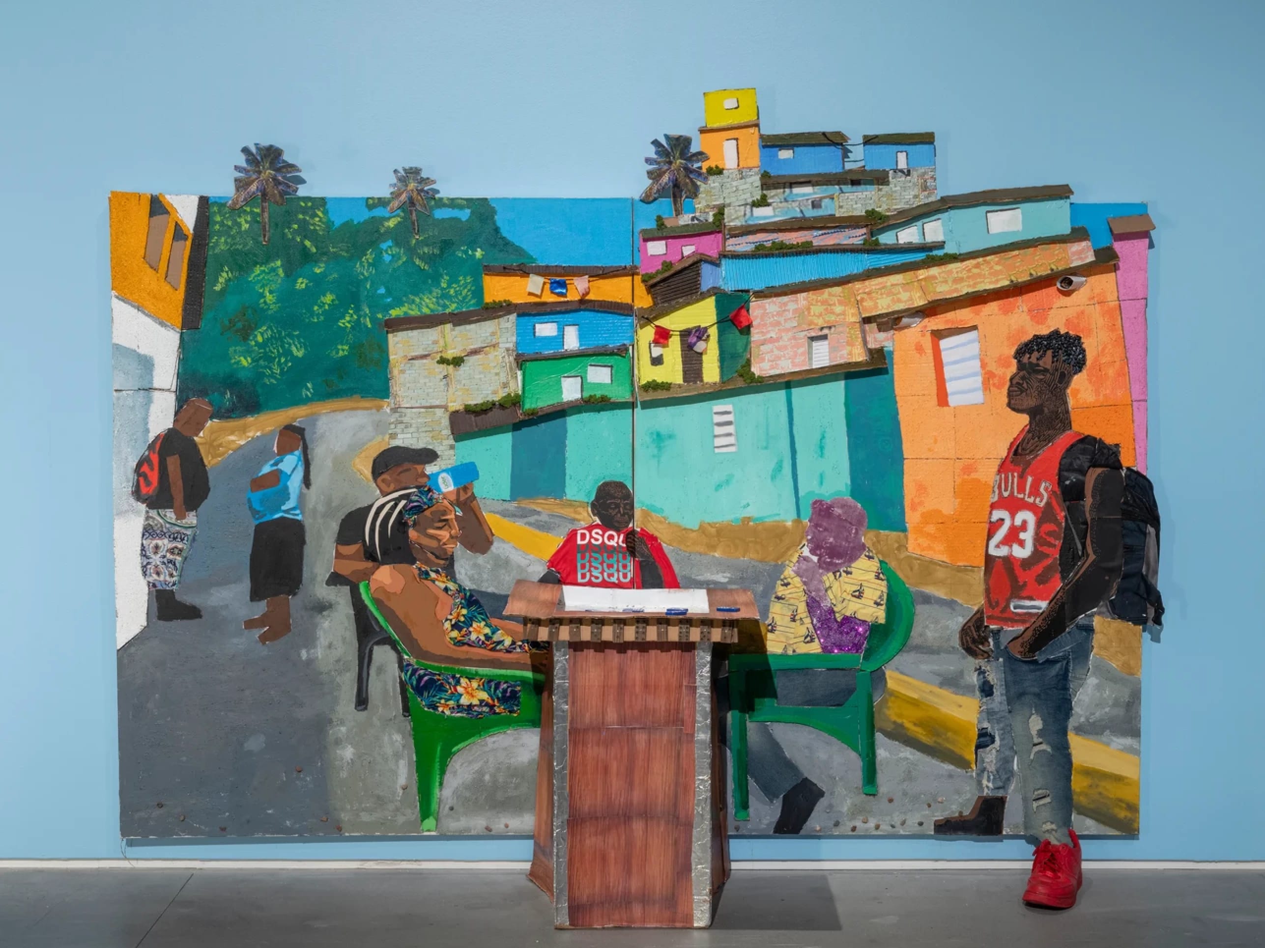 A mixed media art piece depicting a boy at a podium and other people sitting in lawn chairs behind him 