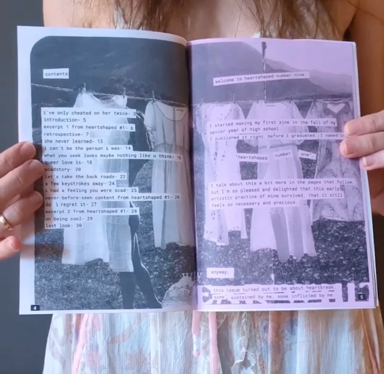 A person holds open a pink zine with images printed on it 