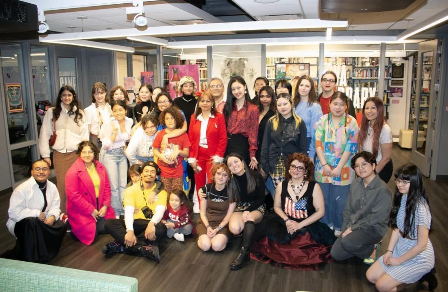 A group of students pose for a photo in the SVA library West