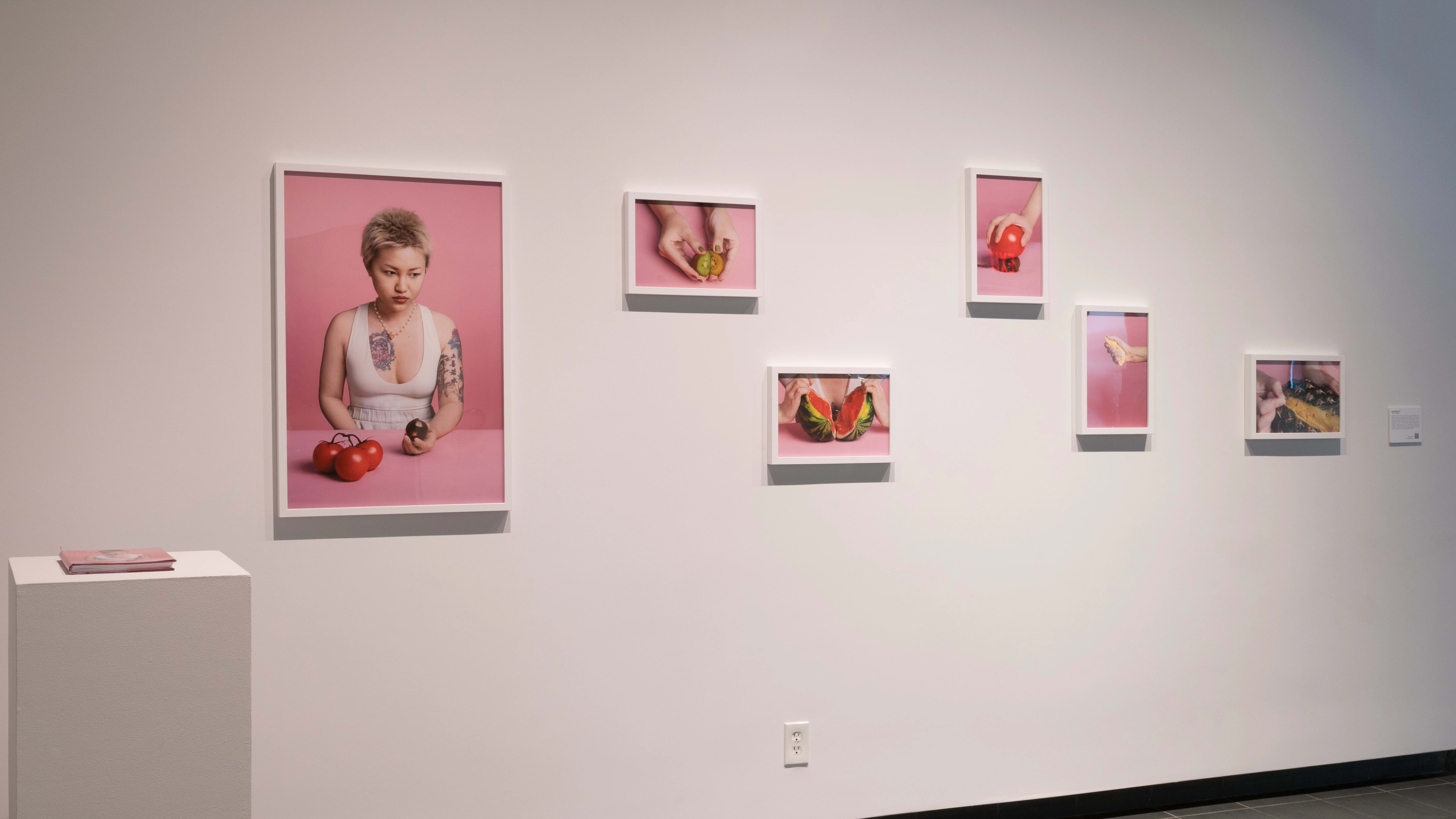 Six photos, one of which is a figure holding vegetables, and the others of which are close-ups of fruit. On the left beside it is a pillar with a book.