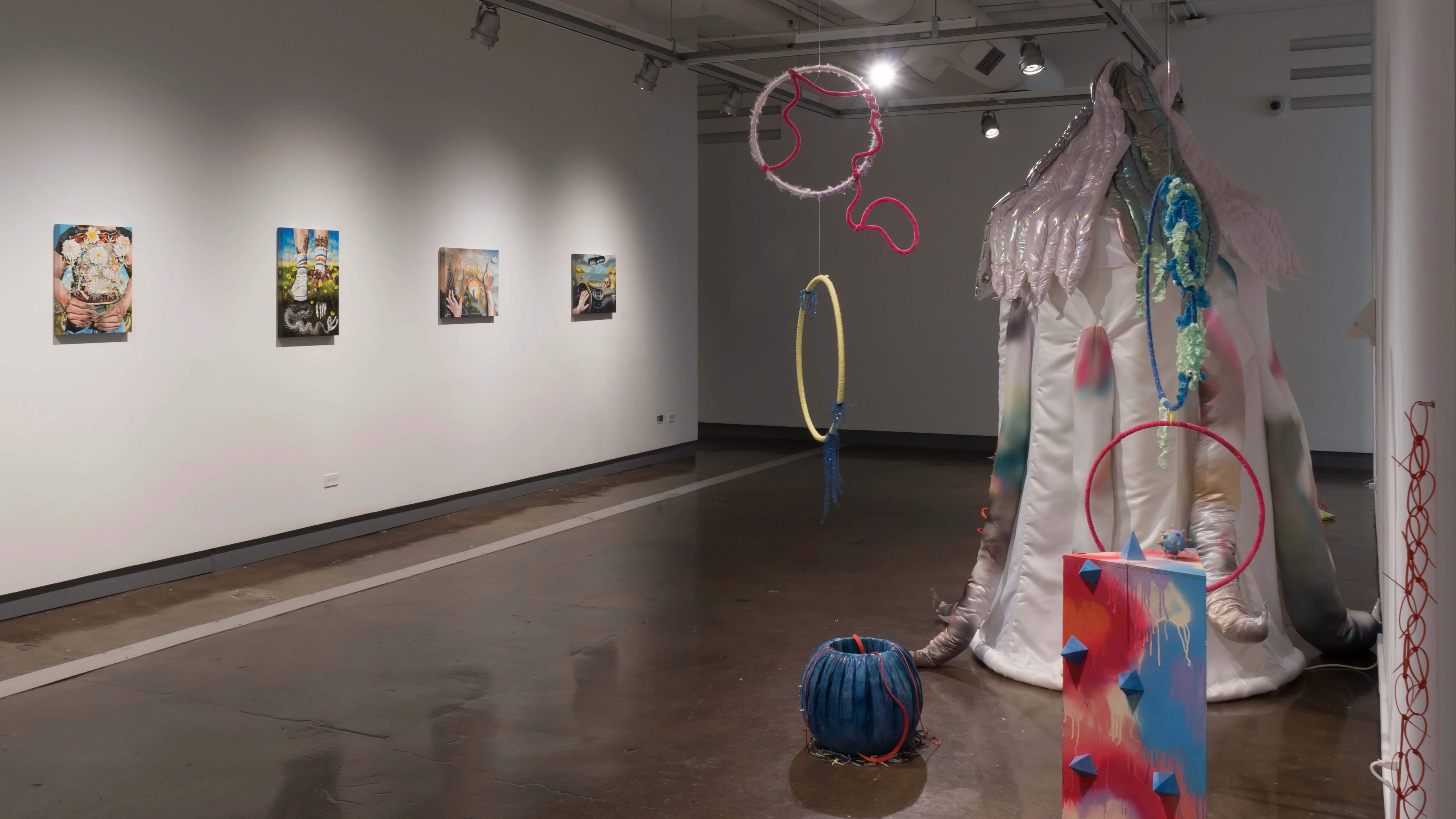 The second gallery with paintings on the left wall and soft-sculptural pieces on the right.