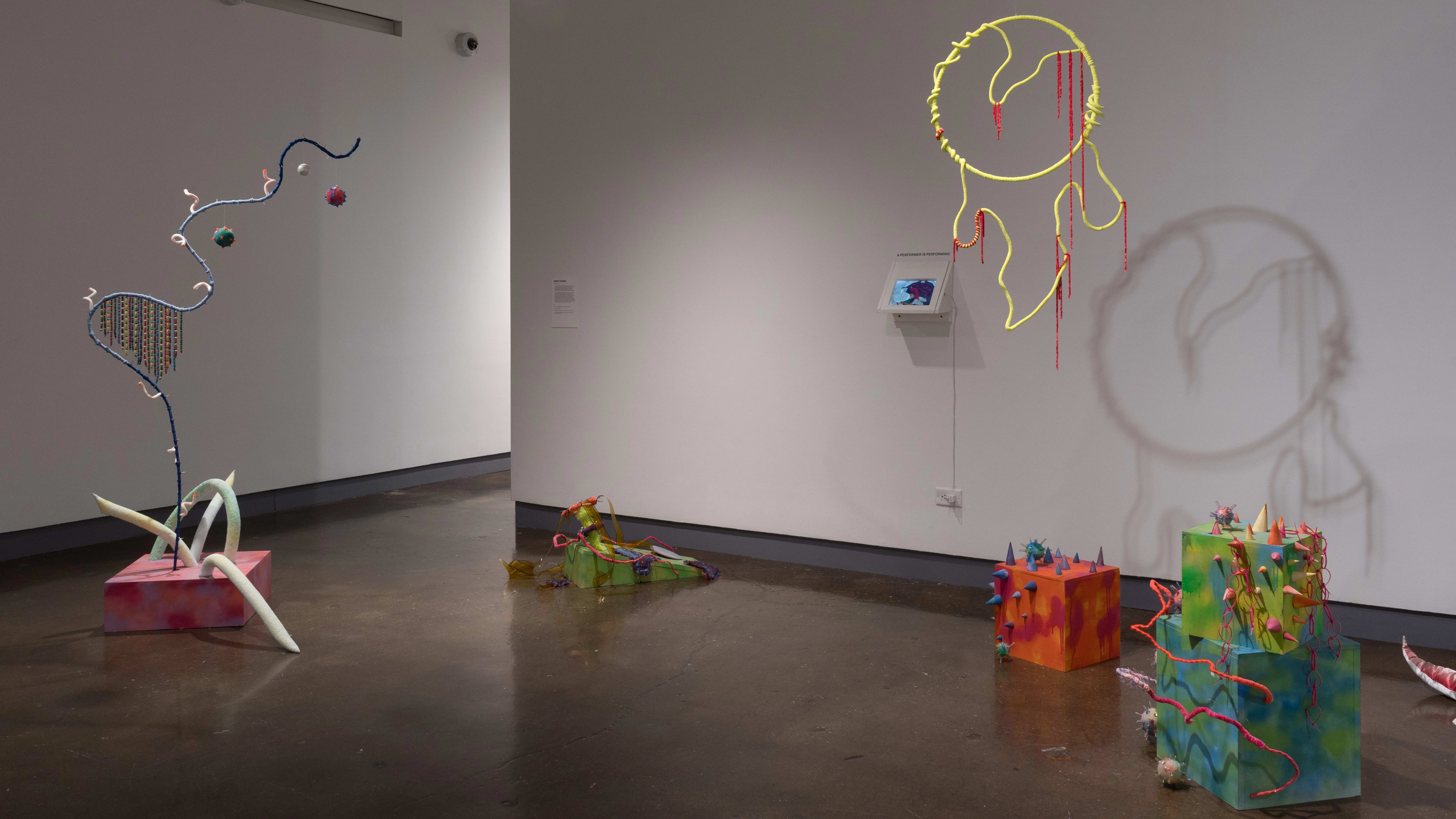 The second gallery with colorful sculptural pieces, along the floor and hung from the ceiling.