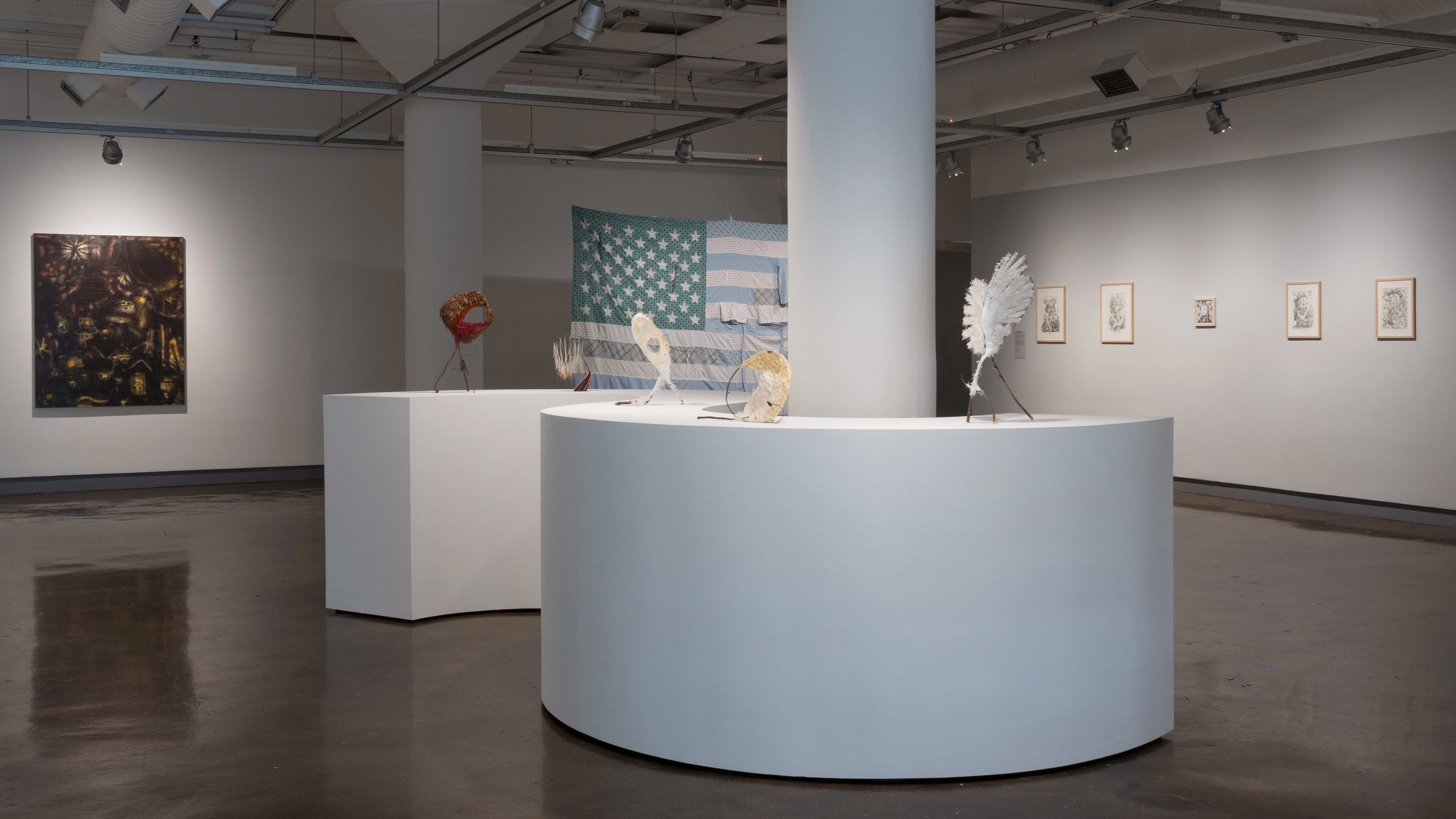 The first gallery in the SVA Chelsea Gallery, where multiple sculptural pieces as well as artworks are hung on the walls.