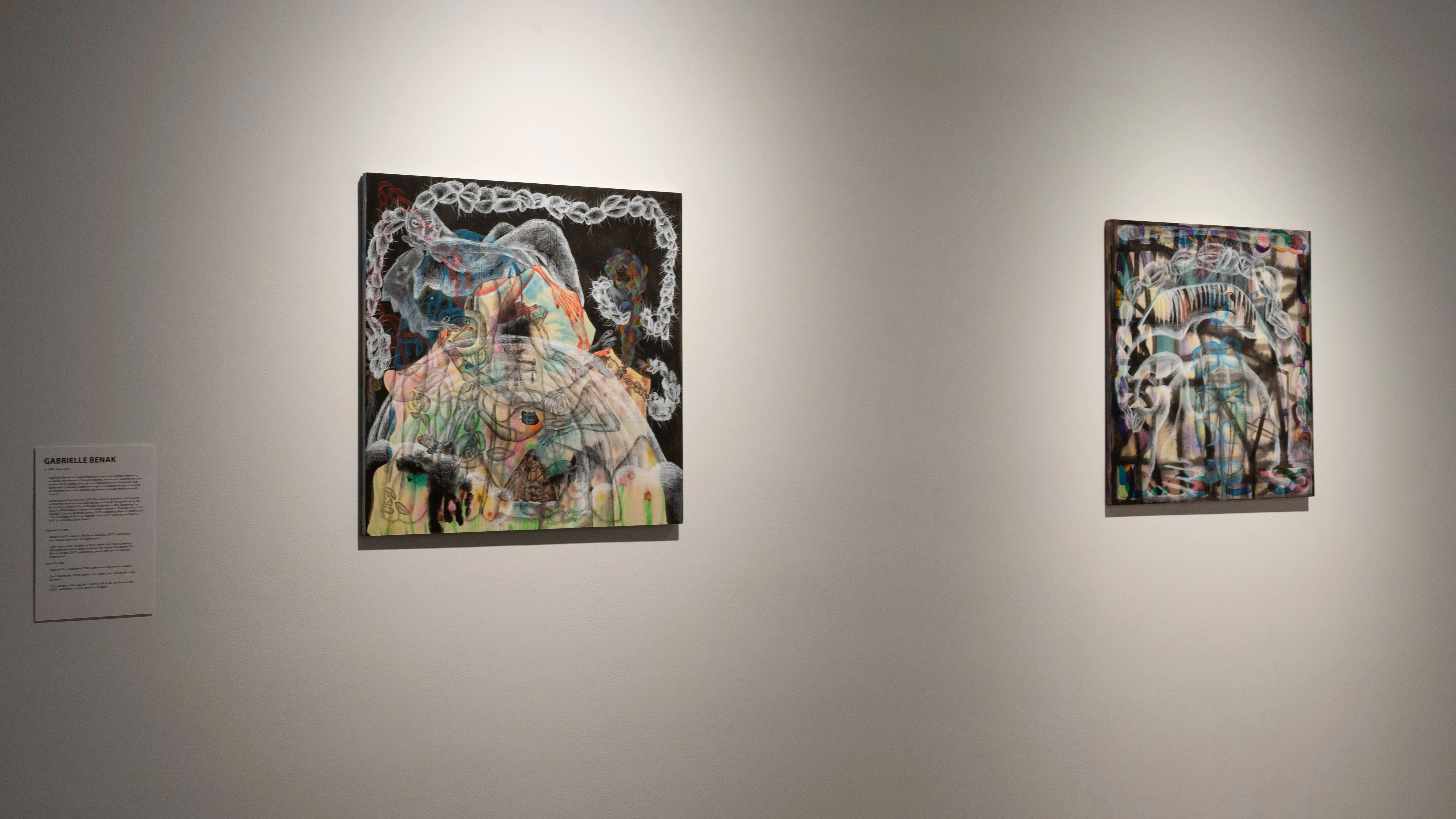 A label on the wall reads Gabrielle Benak beside two artworks. The works are chalk pastel drawings on a dark background.
