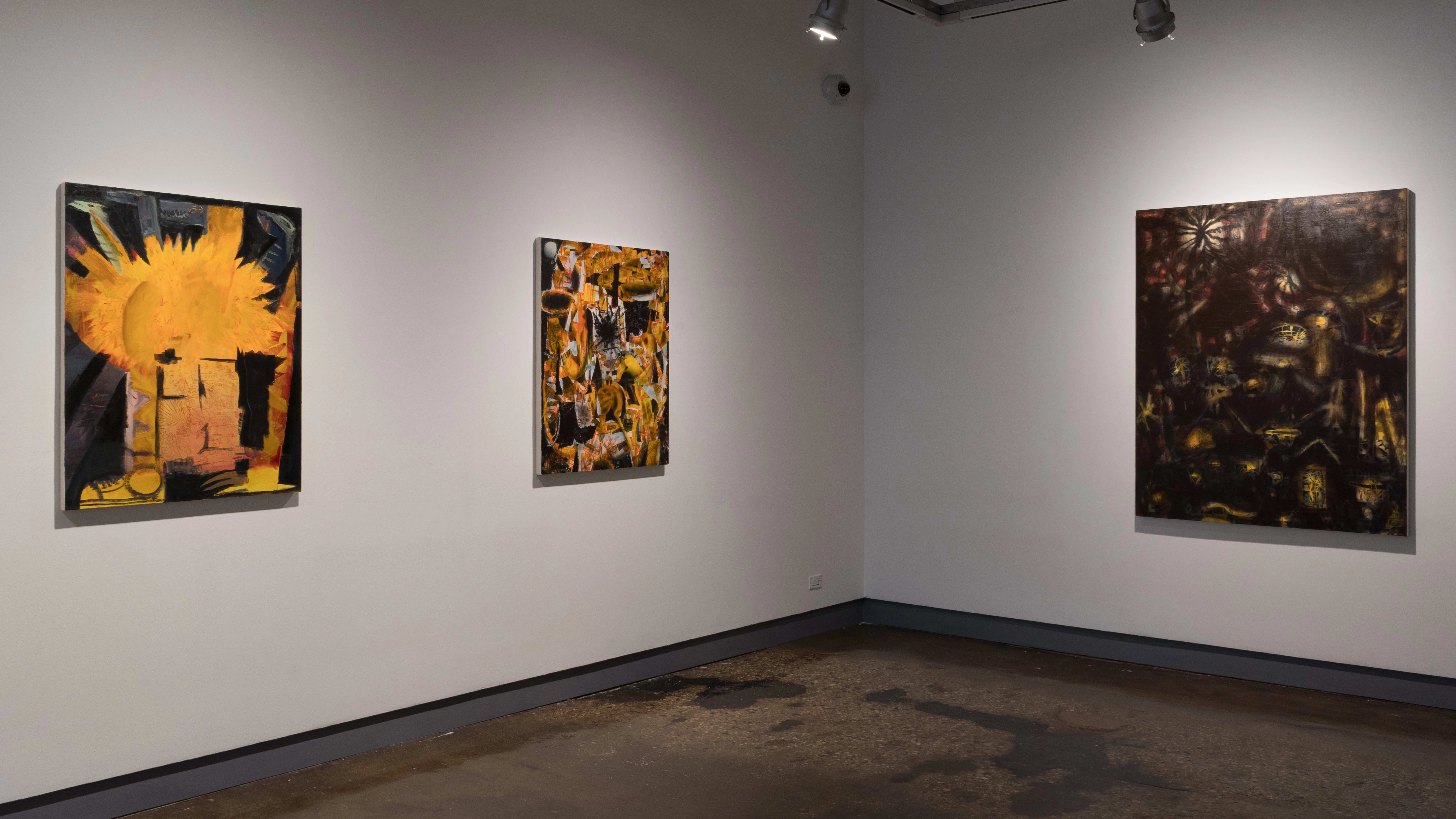 A corner in the SVA Chelsea Gallery with three paintings on the wall.