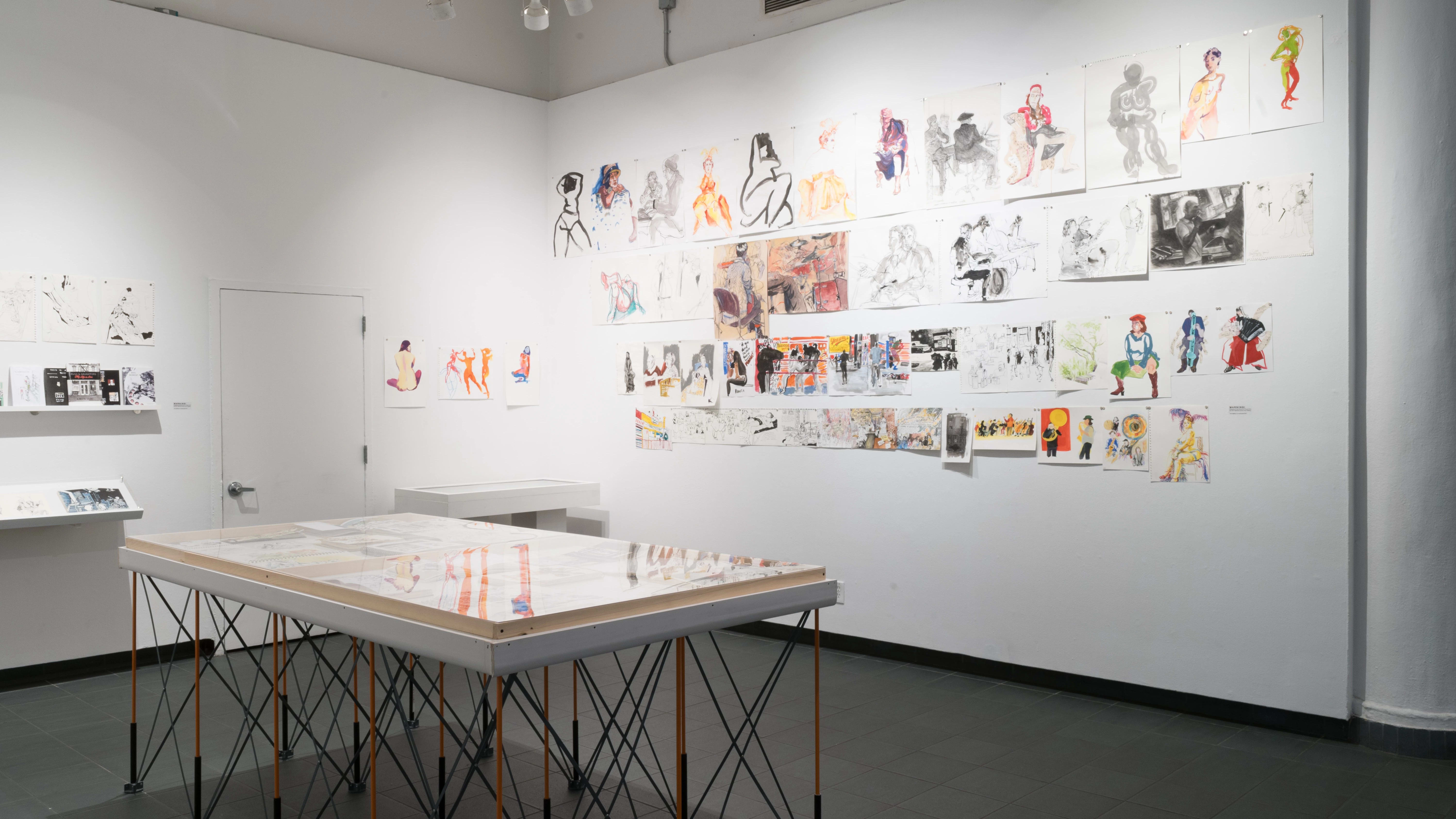 Angled view of the Gramercy front gallery alcove looking closer at the colorful life drawings. The top row seems to most have figure sketches, the second sketches of live bands, the third, people in a boxing gym, and the bottom people in cafes, at concerts, and playing instruments. 