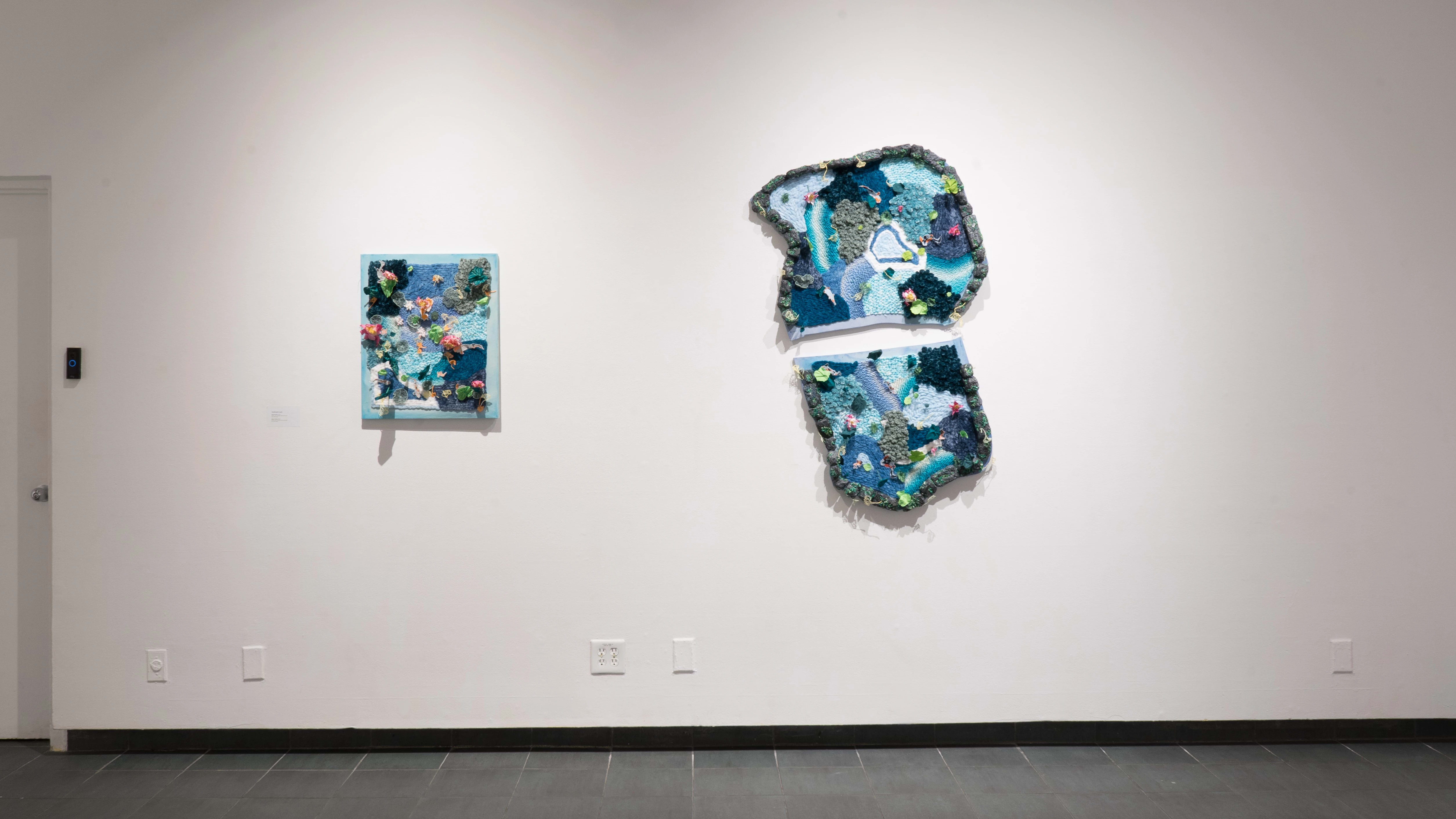 Straight view of a wall in the back gallery of the SVA Gramercy Gallery, showing two mixed media installations depicting small ponds.