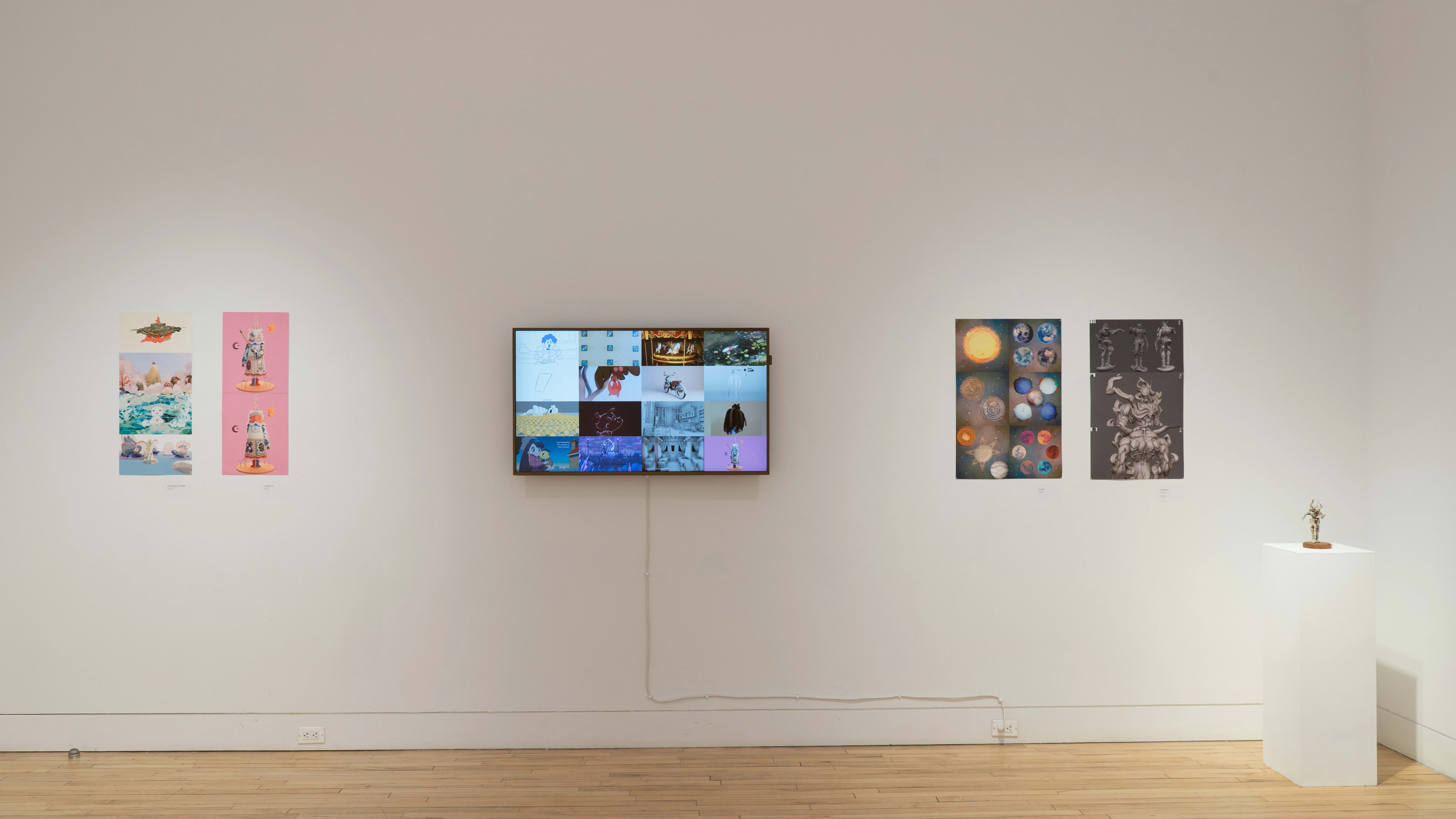 A straight shot of the SVA Flatiron Gallery's north wall, showing four colorful prints by BFA Animation students pinned up on each side of a monitor; a sculpture sits atop a pedestal in the right corner.