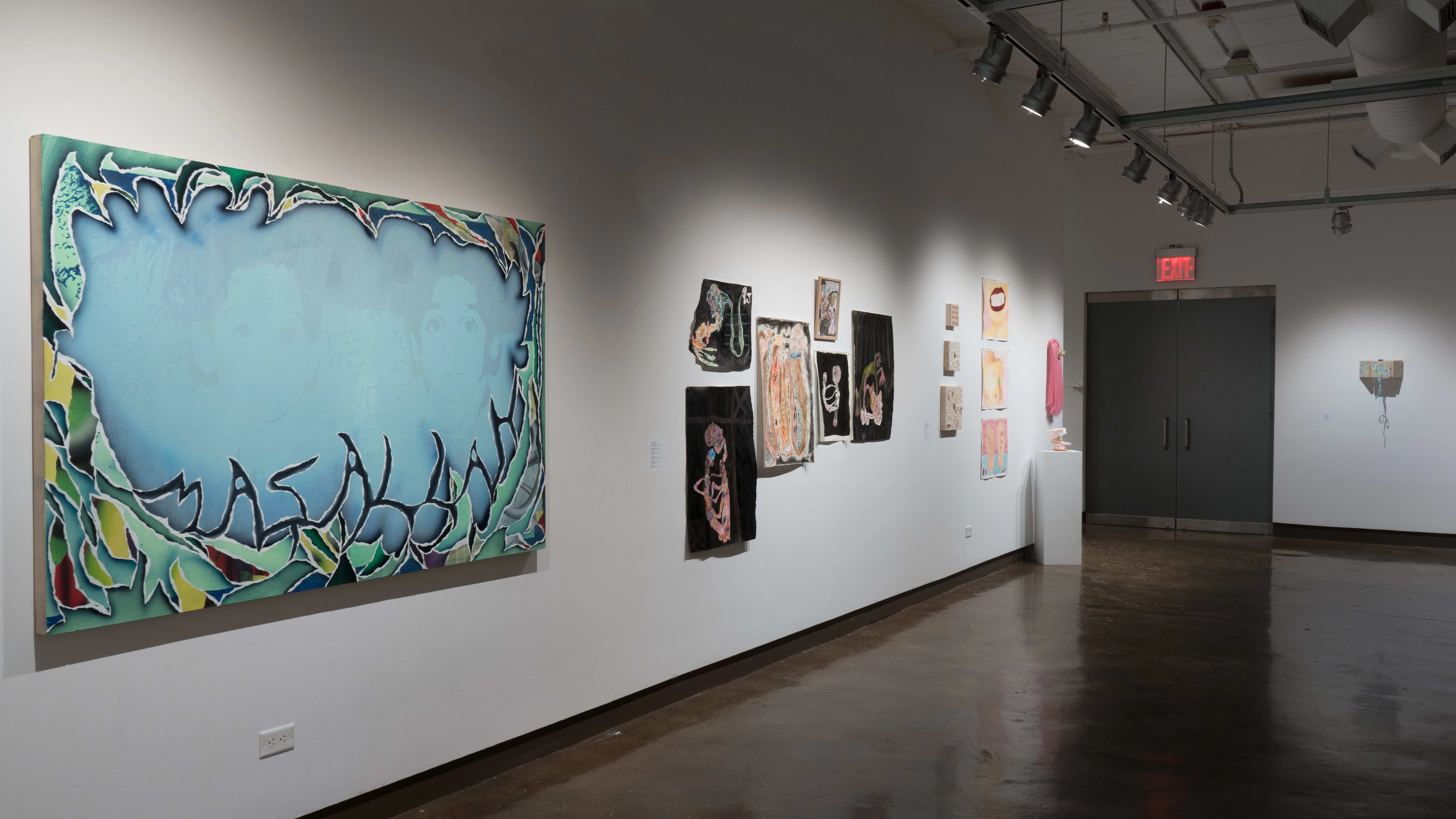 In gallery three, a large horizontal canvas depicts a faded image of two children’s faces, while colorful, textured shapes surround them and spell out “Masallah.” Further along the wall, works on paper using blacks and skin tones hang next to pink and fleshy watercolors and sculptures.