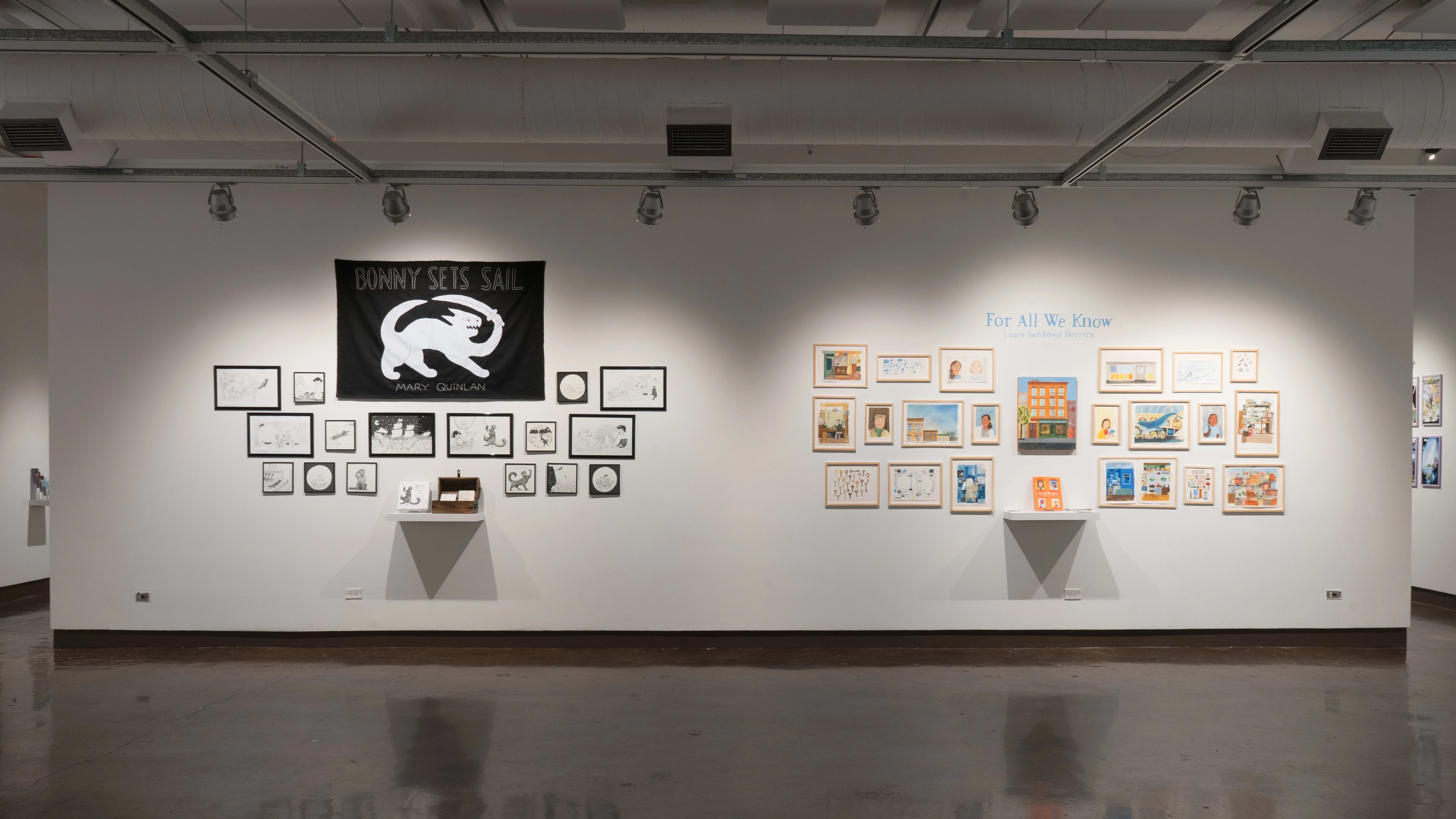 A view of the east wall at the SVA Chelsea Gallery. On the left is a black and white project hung salon style. There is a large black flag with a cat with a sword in white at the top, under the words, “Bonny sets sail.” Another project hung salon-style is on the right, with many colorful framed prints under the title, “For All We Know.”