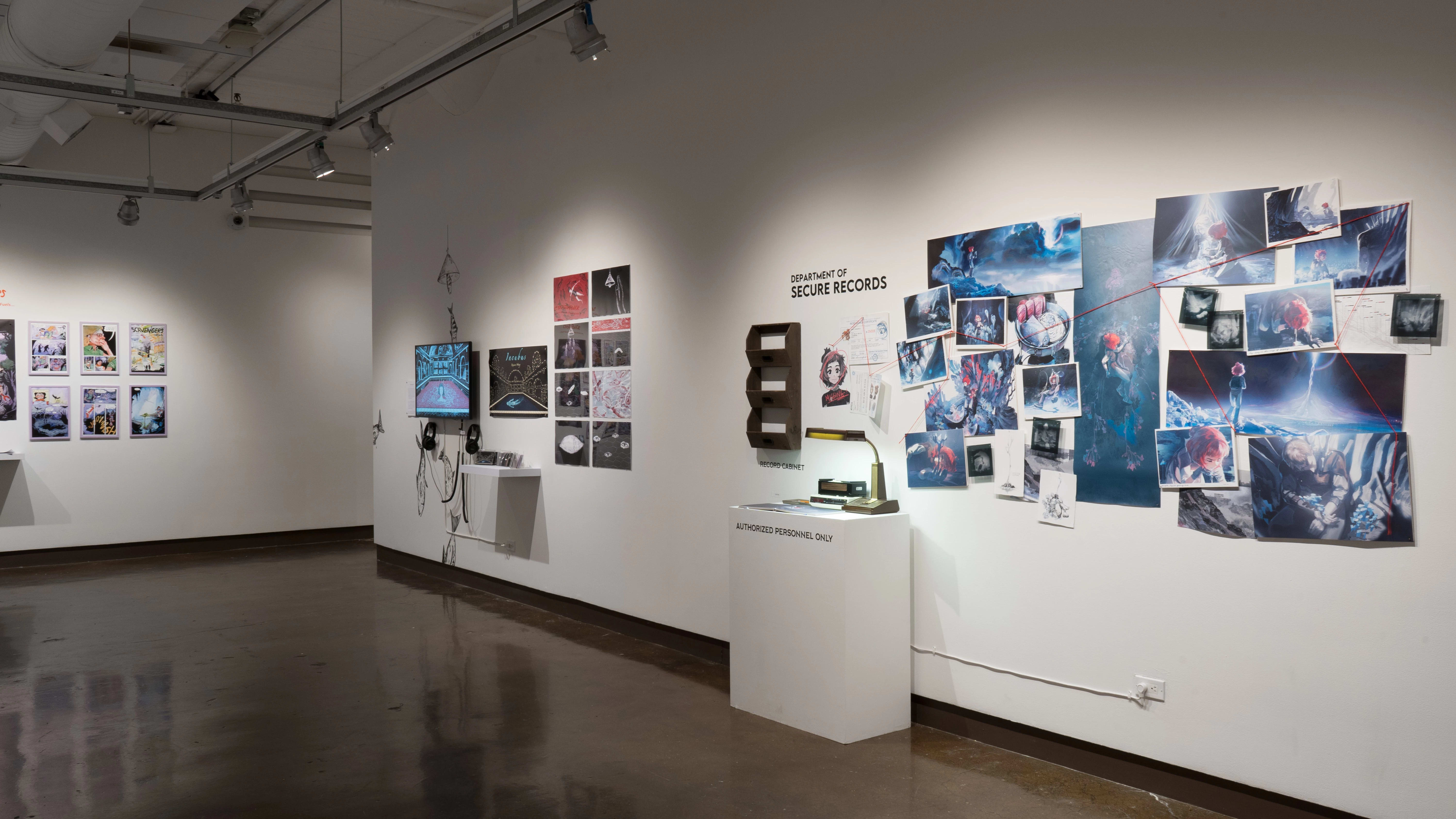 On a wall of gallery two, there are prints hung next to a monitor and headphones. Further to the right, another project’s prints are organized into a constellation, and a red string leads between images like a detective’s investigation board. A small radio and lamp sit on the pedestal beneath them.