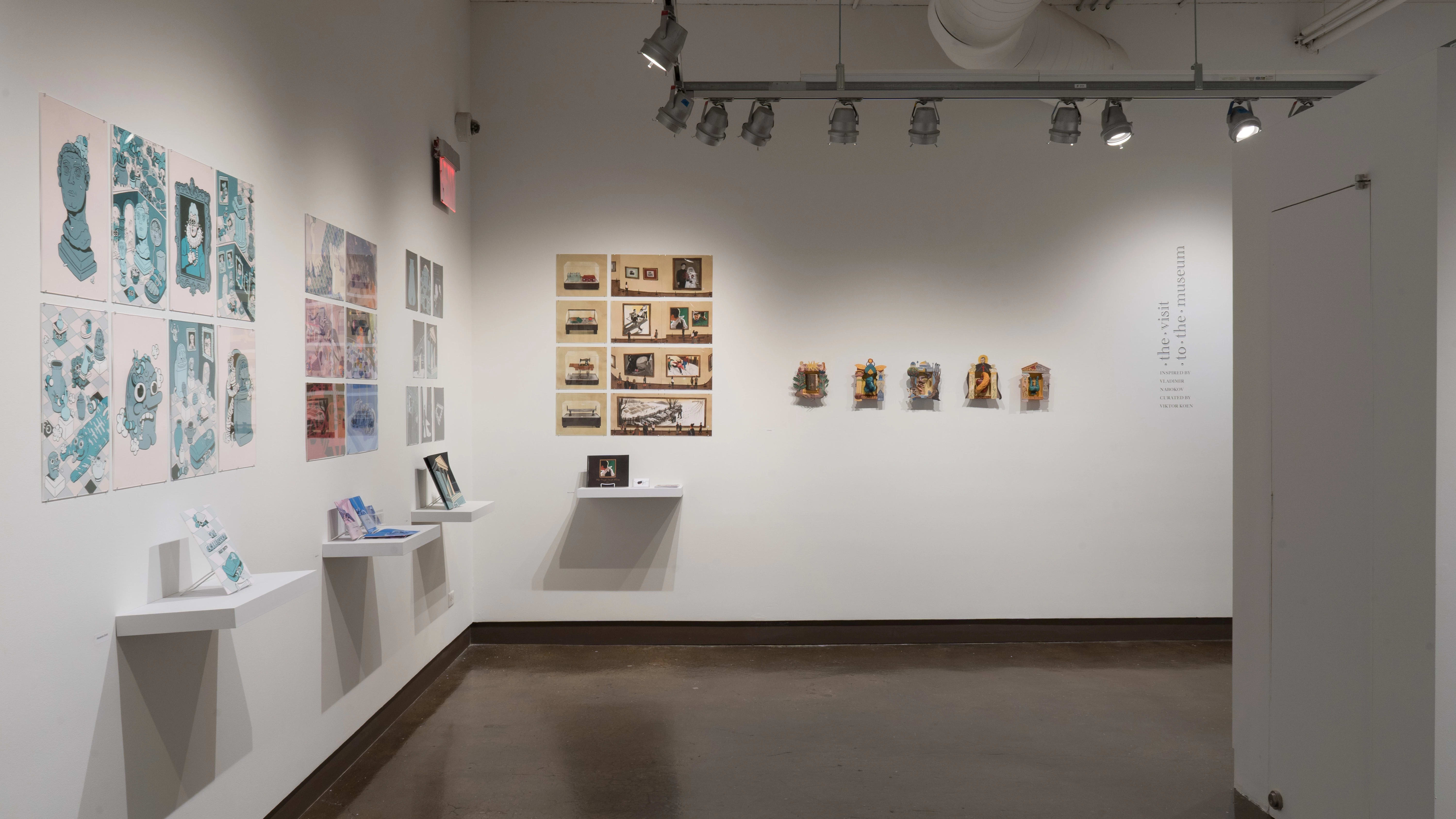 In the right corner of the space, five projects are displayed on the wall side by side. Some projects are presented with pinned prints and books, while others use small sculptures.