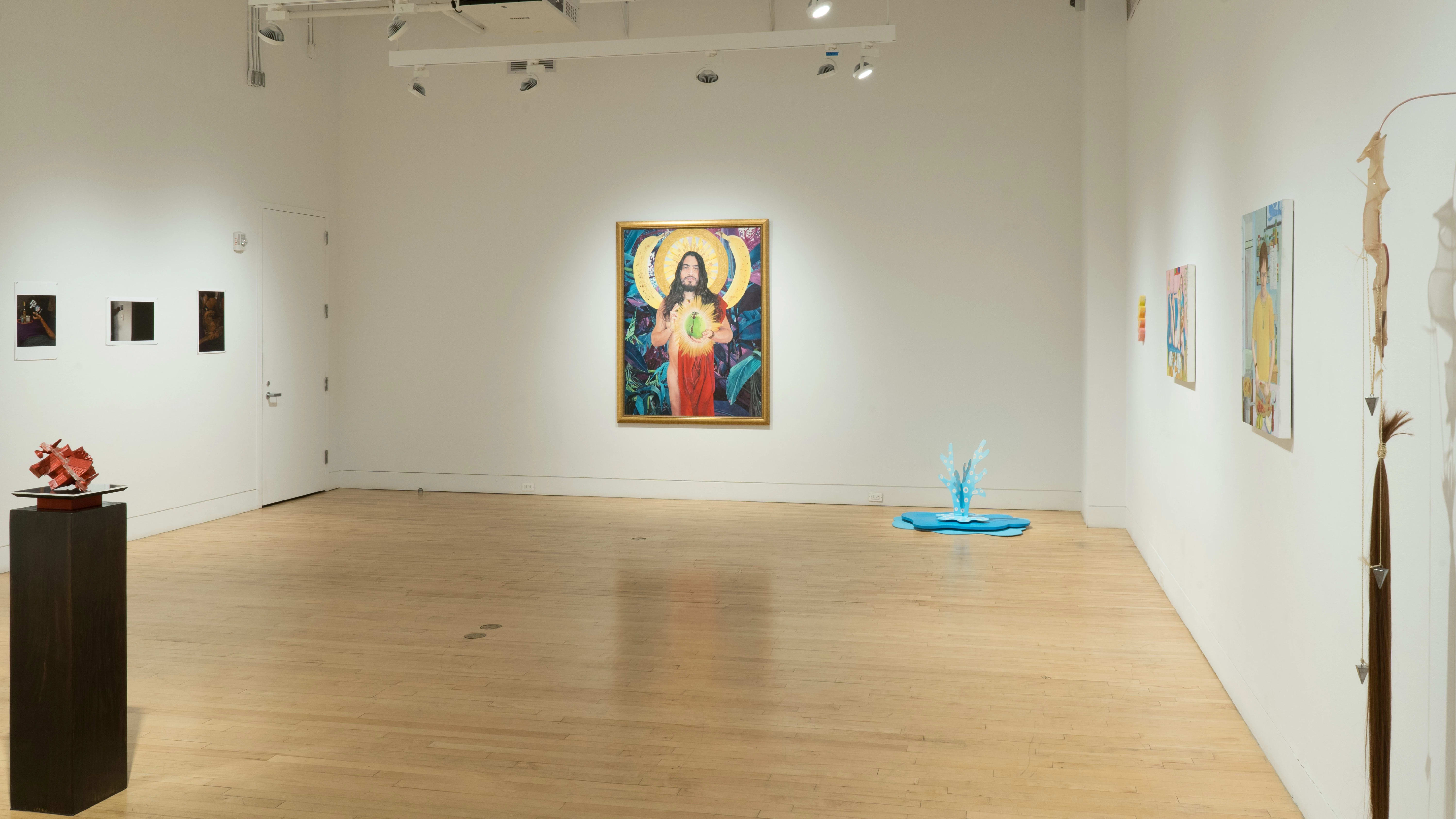 From the corner, most of the gallery is visible, including the saint-like painting, the sculpture on a pedestal, the photos, and the figurative paintings.