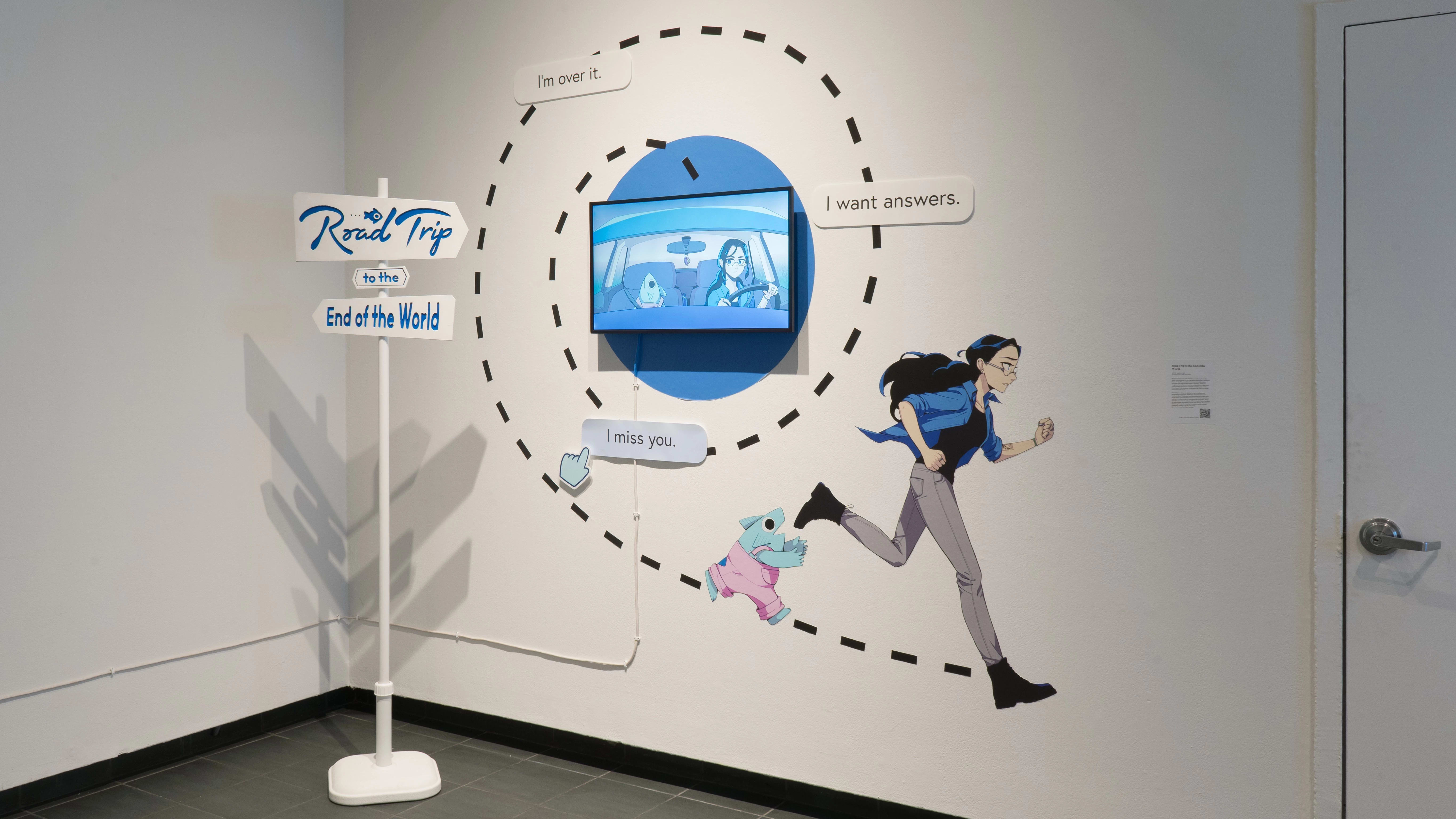 A wooden sign reading “Road Trip to the End of the World” points to an animated work in the exhibition. A trail spirals out from the tv, leading to images of the two main characters of the animation in stride. Text bubbles reading “I’m over it.”, “I want answers.”, and “I miss you.” are over the shape of the trail.