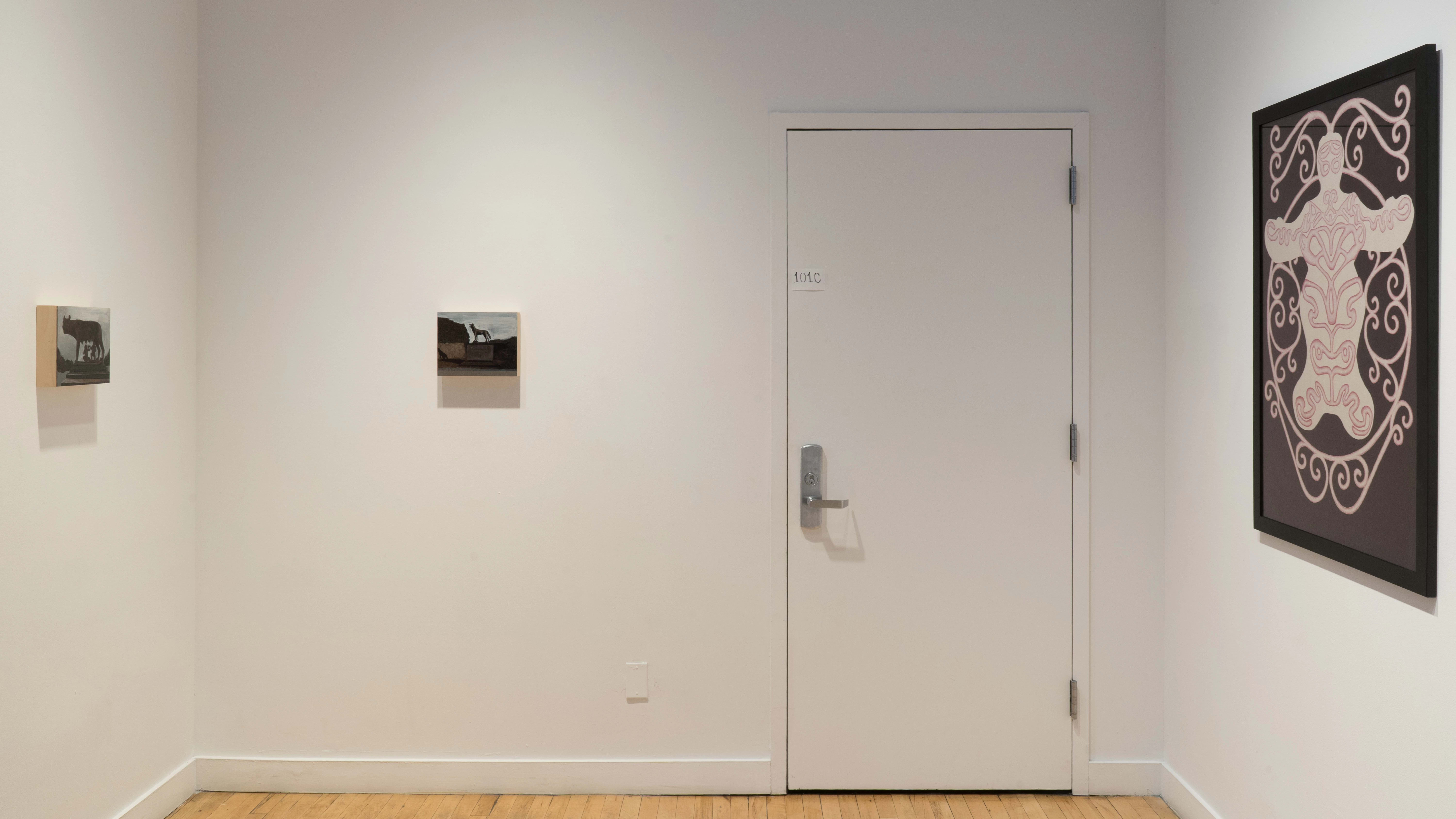 In the alcove outside the gallery, two small paintings of animals hang catty-corner to one another. To the right, a large abstract drawing depicts a body-like shape covered in a swirly pattern.