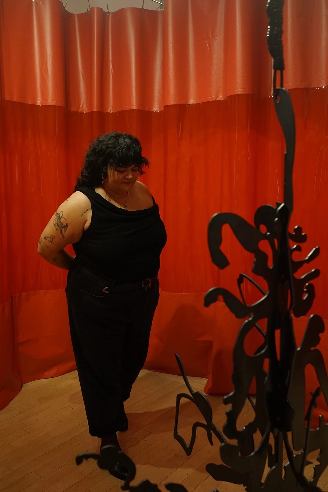The artist in front of her sculpture