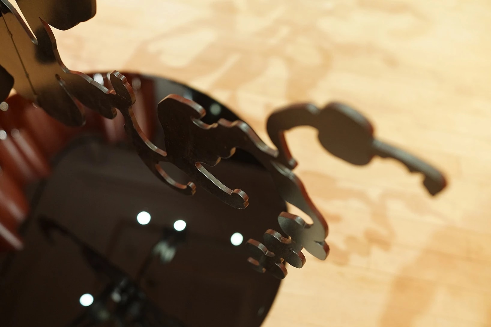 detail shot of the black plexi sculpture over the black circle on the floor