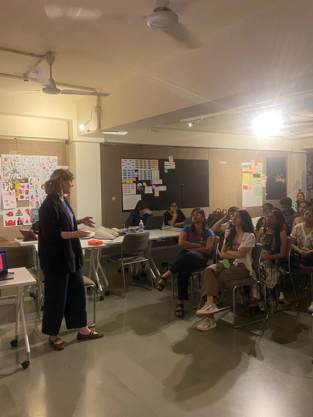 Professor at the front of a classroom of students giving a lecture.