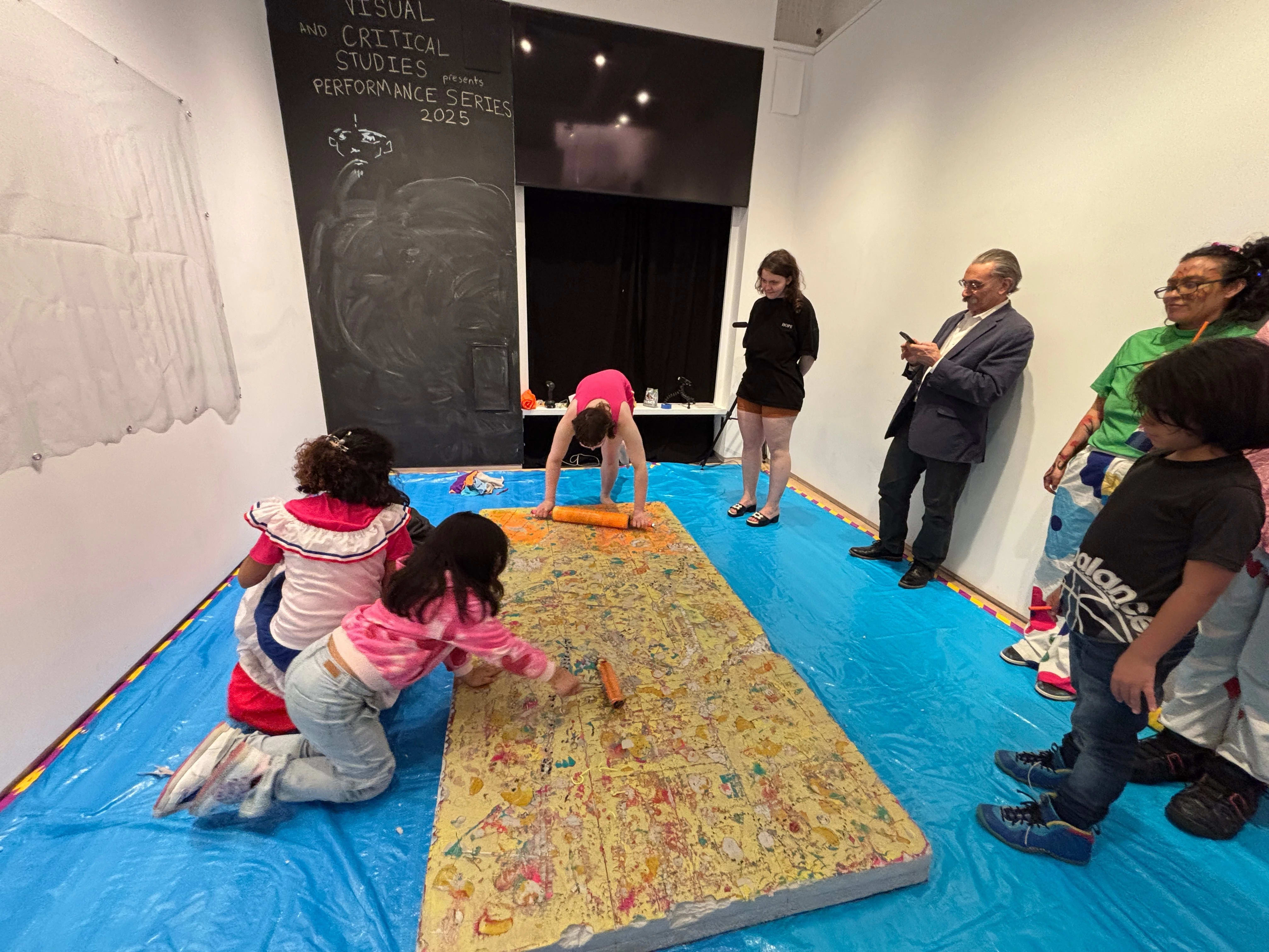 Audience participating in performative printmaking project