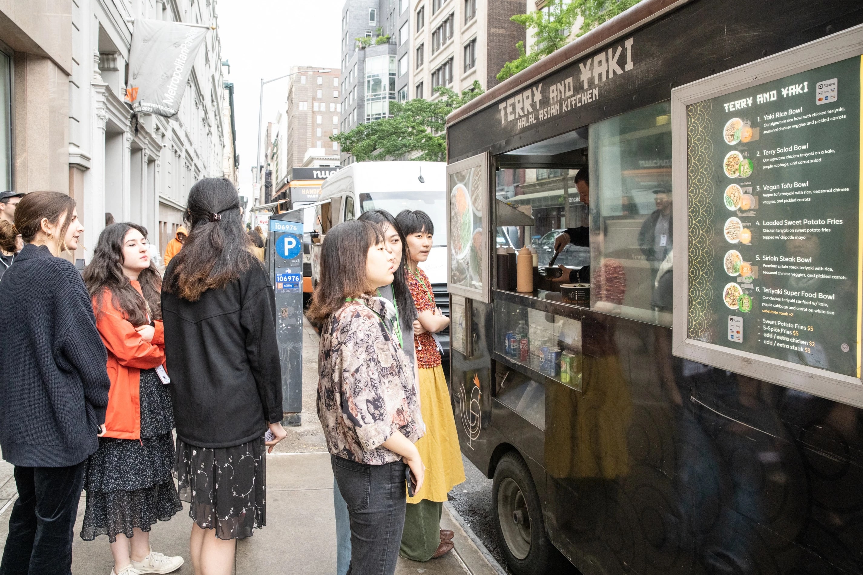 A student chats with a guest about their display of work.