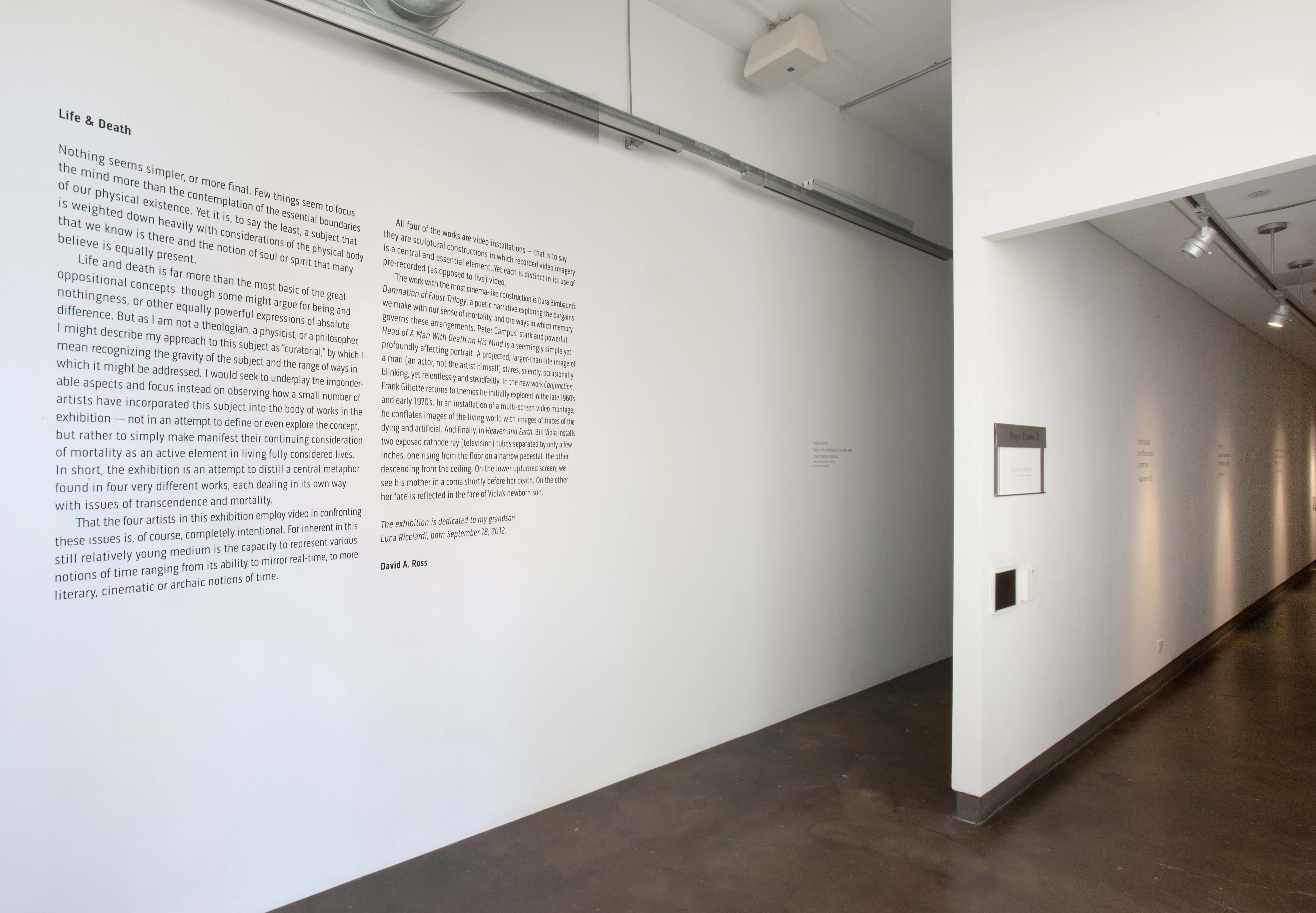 An exhibit wall with an article about life and death.